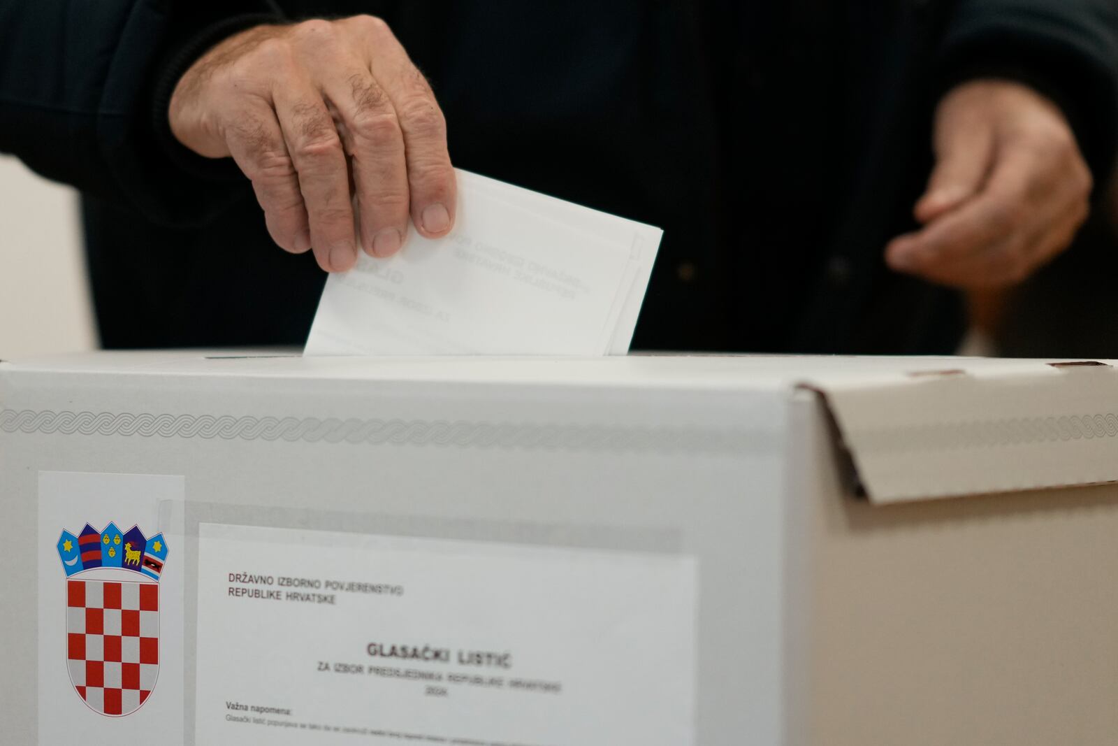 A man casts his ballot during a presidential election at a polling station in Zagreb, Croatia, Sunday, Dec. 29, 2024. (AP Photo/Darko Bandic)