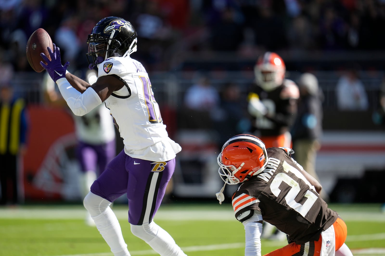 Baltimore Ravens wide receiver Nelson Agholor (15) celebrates a touchdown in front of Cleveland Browns cornerback Denzel Ward (21) during the first half of an NFL football game in Cleveland, Sunday, Oct. 27, 2024. (AP Photo/Sue Ogrocki)