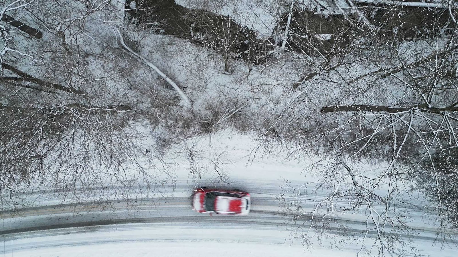 A car drives on Elk Creek Road as snow falls in Madison Twp. Sunday, Jan. 5, 2025. NICK GRAHAM/STAFF