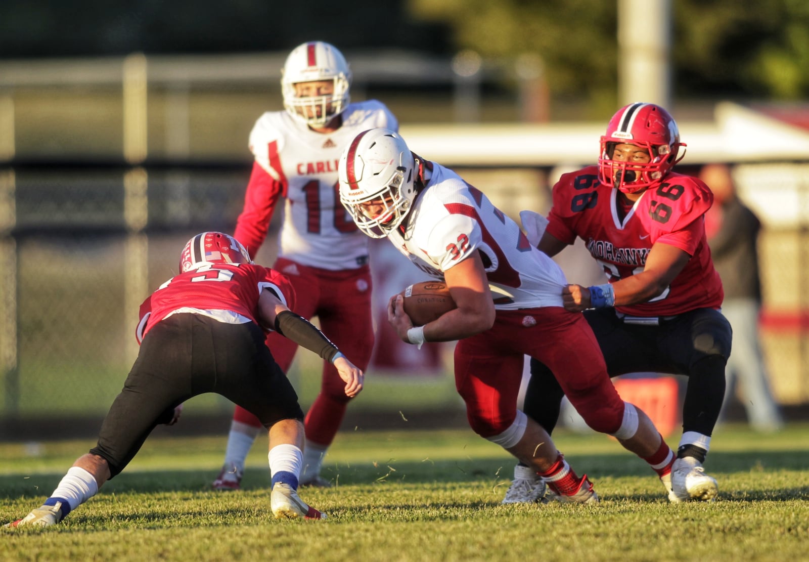 Carlisle's Jayden Sweeney tries to escape the grasp of a Madison defender during Friday night's game. Nick Graham/STAFF