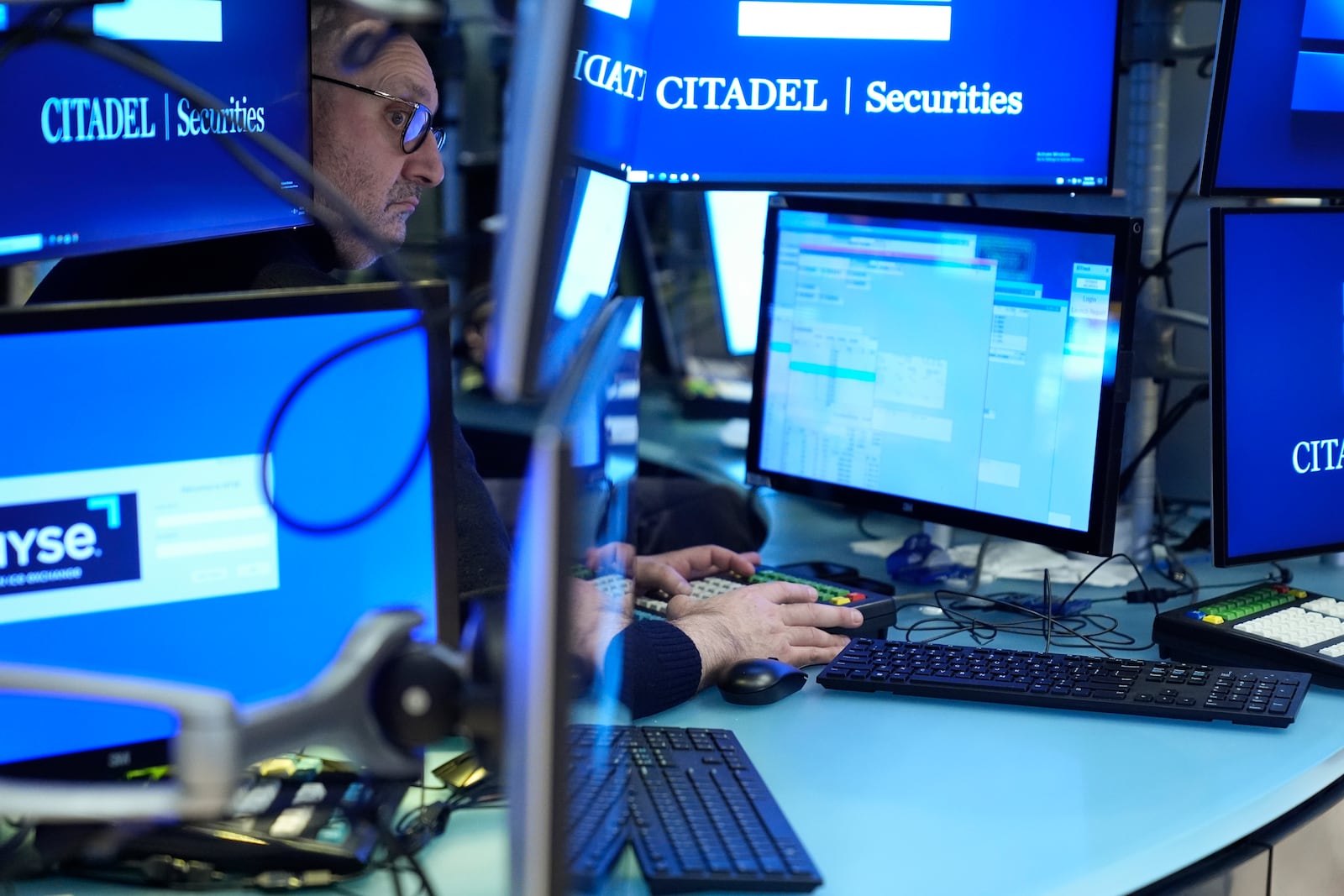 People work on the floor at the New York Stock Exchange in New York, Monday, Feb. 24, 2025. (AP Photo/Seth Wenig)