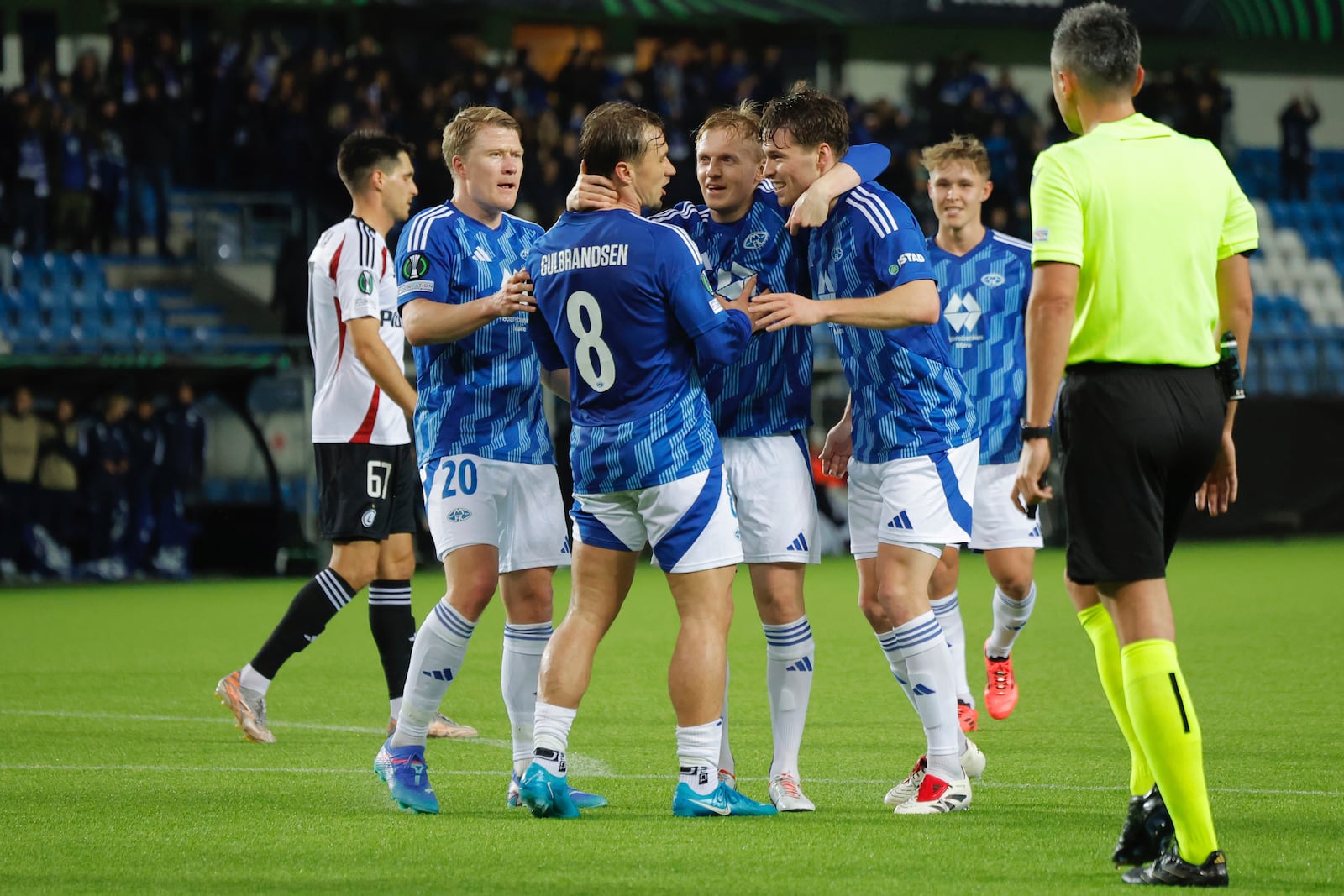 Molde's scorer Fredrik Gulbrandsen, third left, and his teammates celebrate their side's third goal during the Conference League round of 16 first leg soccer match between Molde FK and Legia Warszawa in Molde, Norway, Thursday, March 6, 2025. (Svein Ove Ekornesvag/NTB Scanpix via AP)