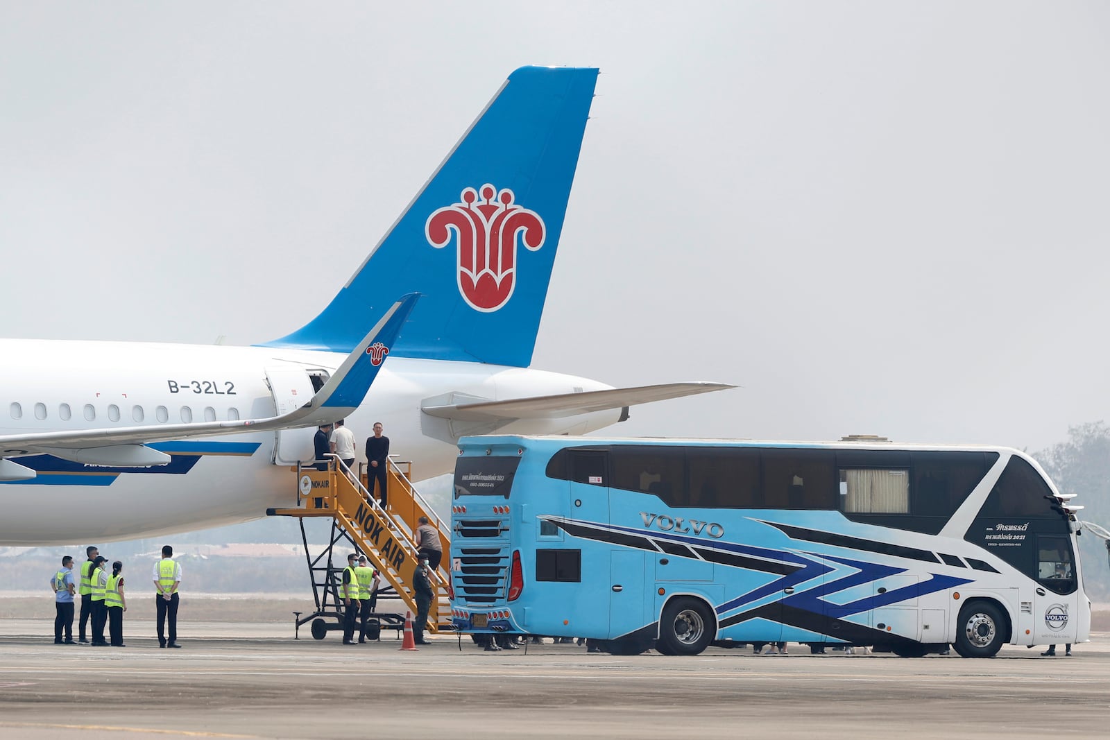 Chinese nationals, believed to have worked at scam centers in eastern Myanmar, board a plane at Thailand's Mae Sot International Airport before sent back to China on Thursday, Feb. 20, 2025. (AP Photo/Sarot Meksophawannakul)