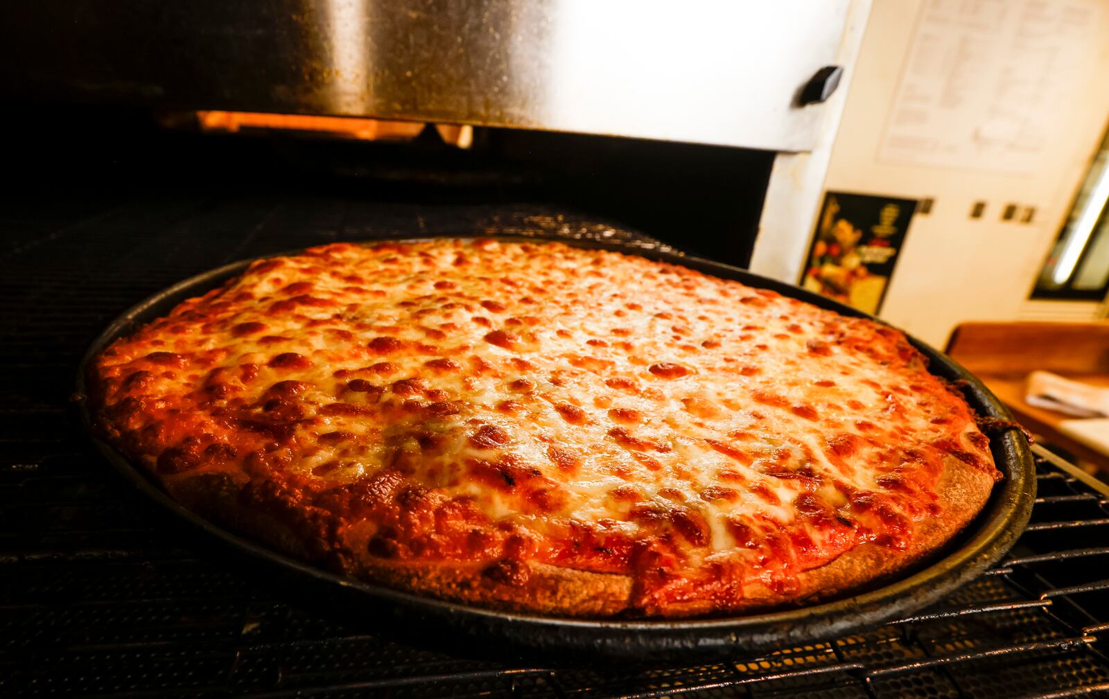 Chuck Vitale prepared a pizza order at Chester's Pizzeria on Dixie Highway in Hamilton last summer. NICK GRAHAM/FILE 