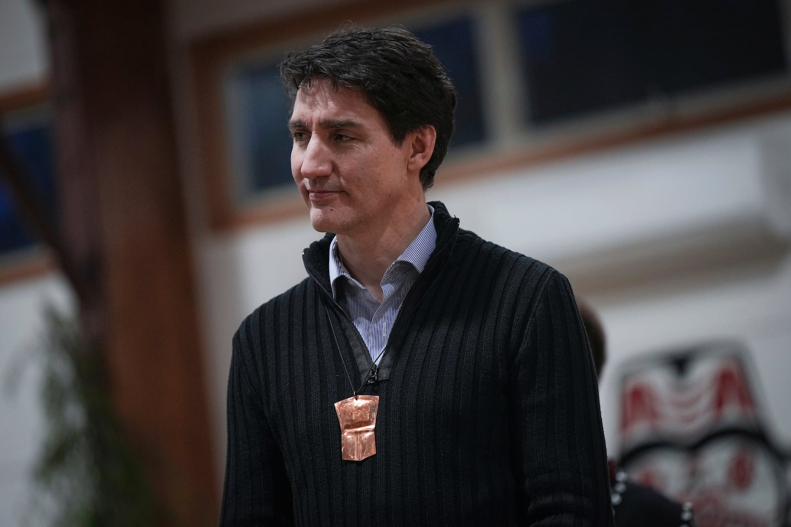 Canada's Prime Minister Justin Trudeau wears a copper necklace while listening during a community gathering to celebrate a land title agreement with the Haida Nation, in Skidegate, British Columbia, on Haida Gwaii, Monday, Feb. 17, 2025. (Darryl Dyck/The Canadian Press via AP)