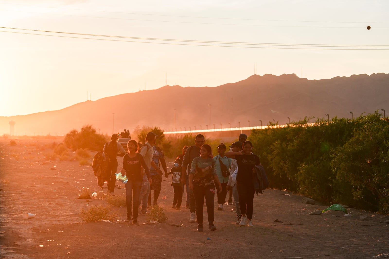 
                        FILE — Migrants walk along the Rio Grande in search of a place to cross the U.S.-Mexico border, in Ciudad Juarez, Mexico, on June 4, 2024. In the months since President Biden imposed sweeping restrictions on asylum at the U.S.-Mexico border, the policy appears to be working exactly as he hoped and his critics feared. (Paul Ratje/The New York Times)
                      