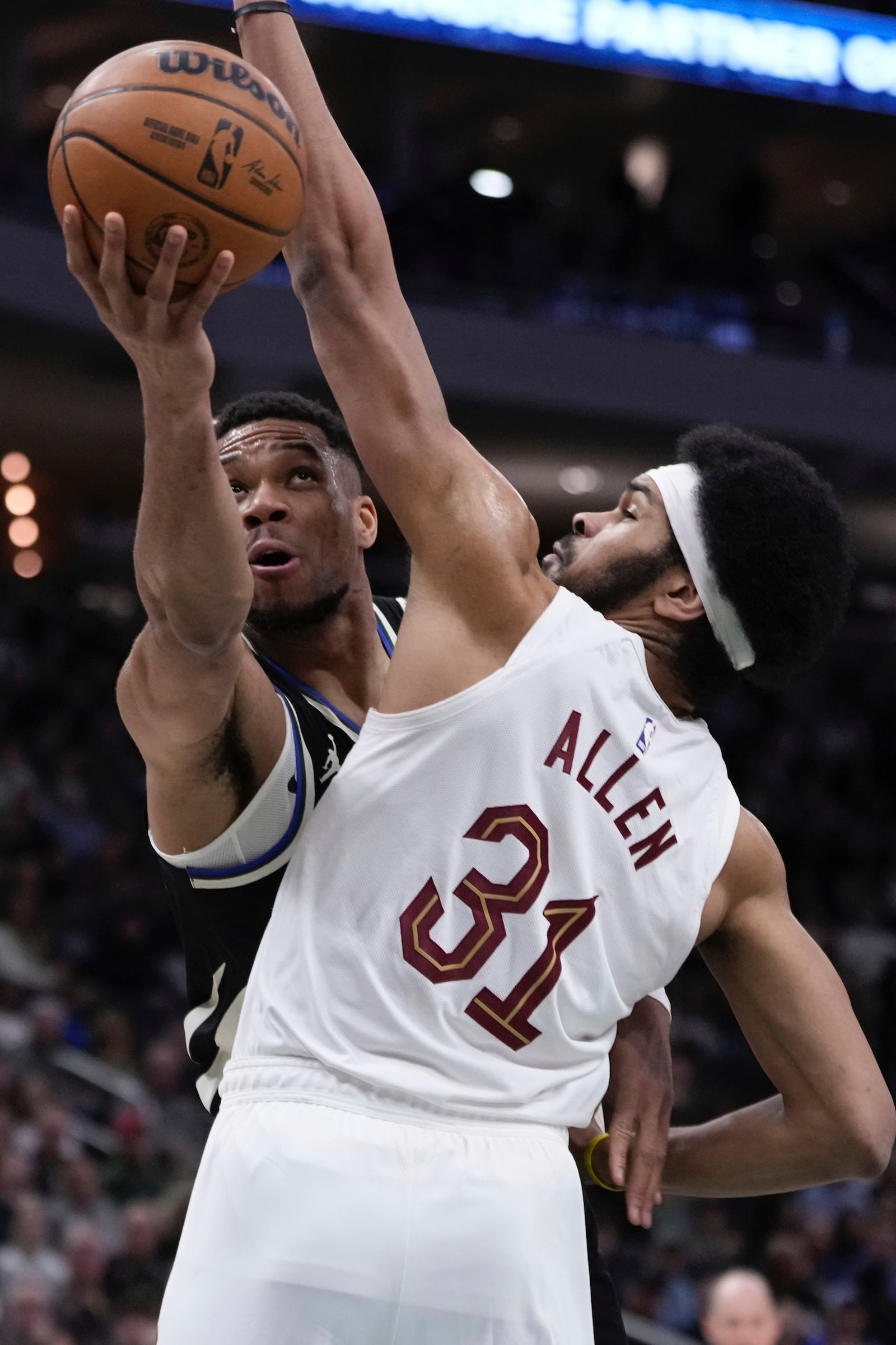 Milwaukee Bucks' Giannis Antetokounmpo shoots past Cleveland Cavaliers' Jarrett Allen during the first half of an NBA basketball game Sunday, Mar. 9, 2025, in Milwaukee. (AP Photo/Morry Gash)