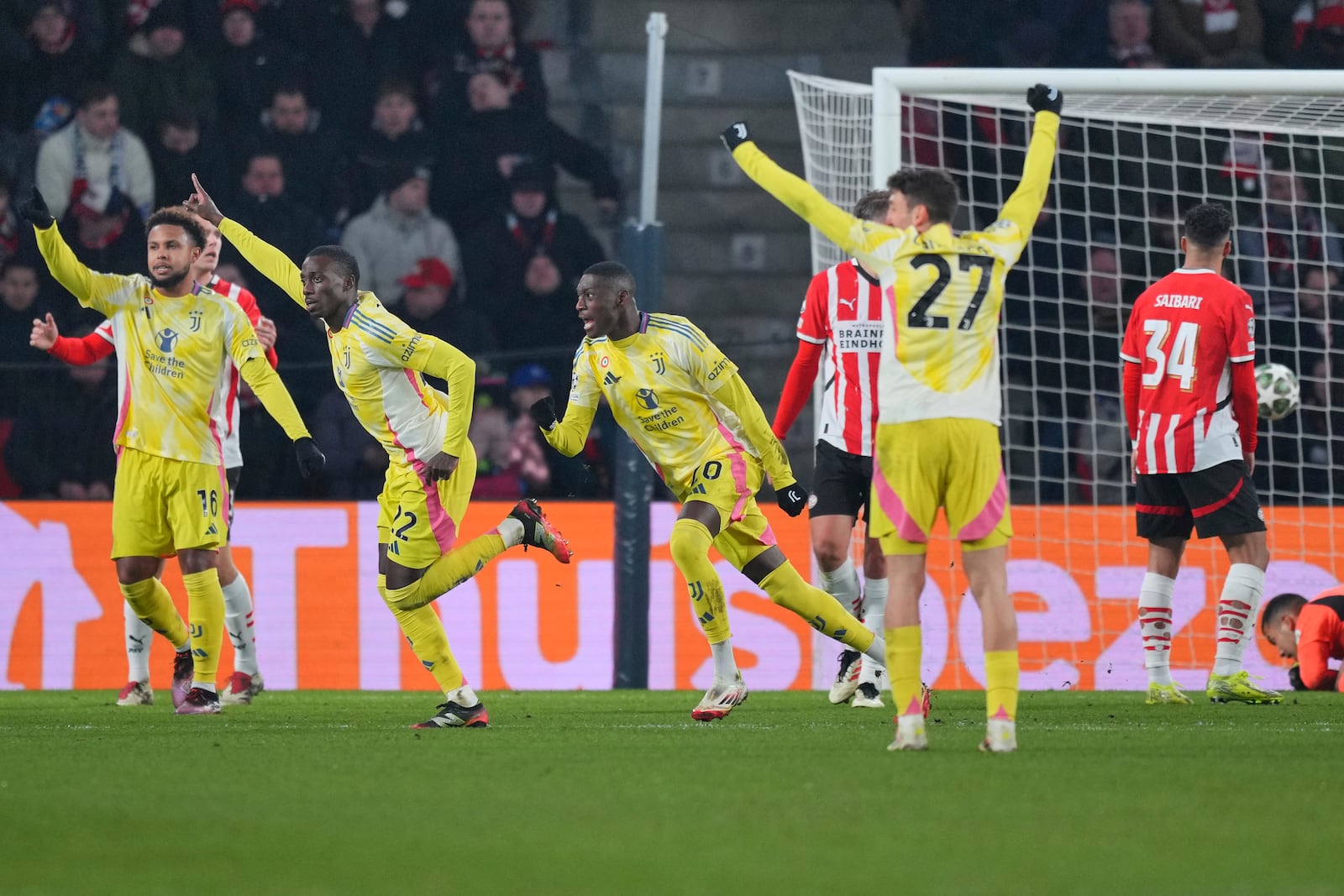 Juventus' Timothy Weah, second left, celebrates after scoring his side's opening goal during the Champions League playoff second leg soccer match between PSV and Juventus at Phillips Stadium in Eindhoven, Netherlands, Wednesday, Feb.19, 2025. (AP Photo/Peter Dejong)