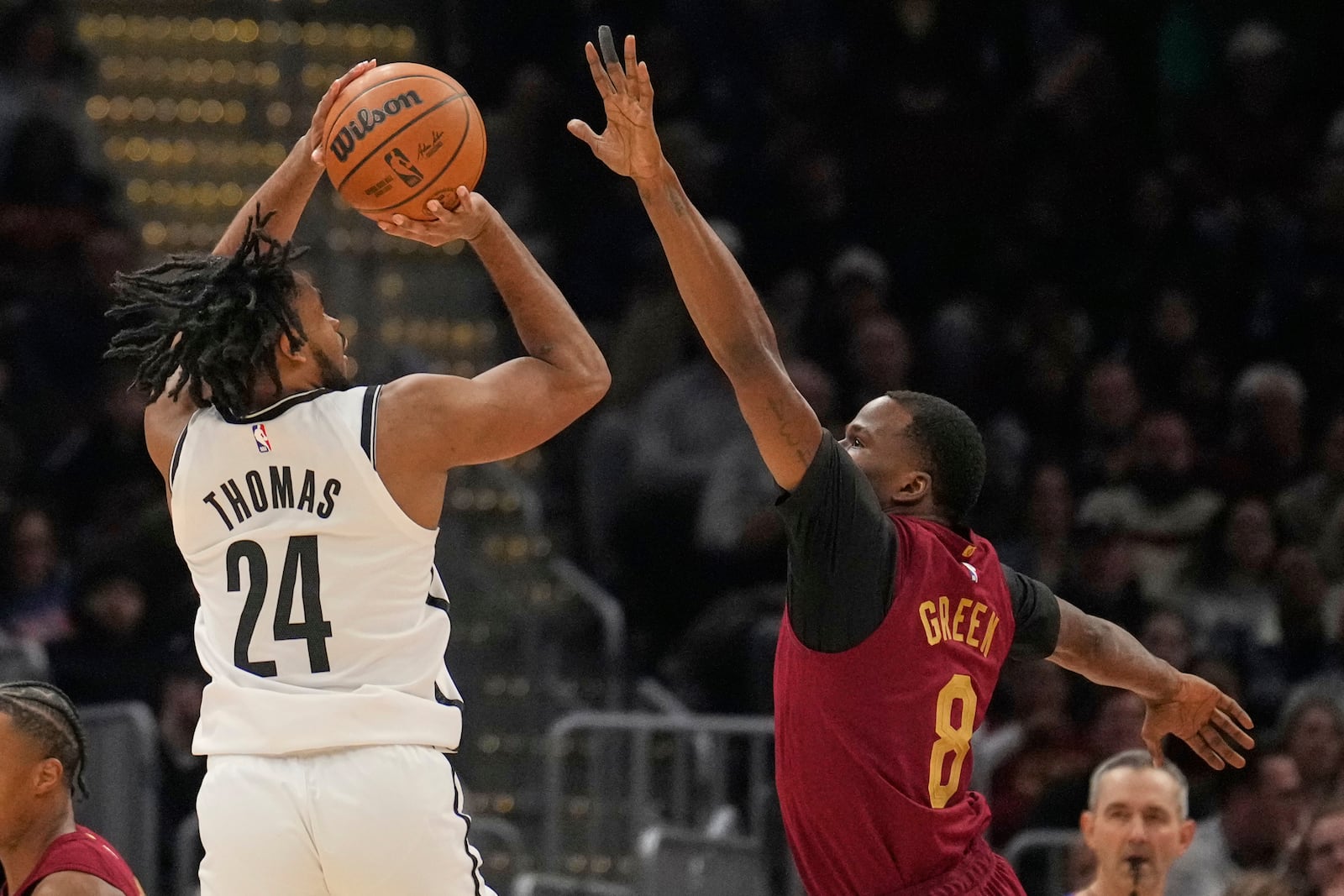 Brooklyn Nets guard Cam Thomas shoots as Cleveland Cavaliers guard Javonte Green (8) defends in the first half of an NBA basketball game Tuesday, March 11, 2025, in Cleveland. (AP Photo/Sue Ogrocki)