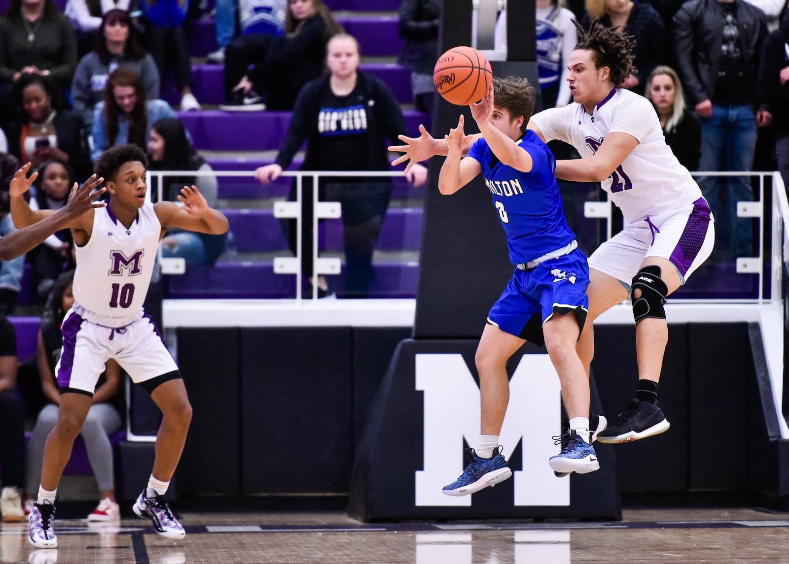 Middletown’s Chris Stallworth tries to block a pass by Hamilton’s Payton Pennington on Friday night at Wade E. Miller Arena in Middletown. NICK GRAHAM/STAFF