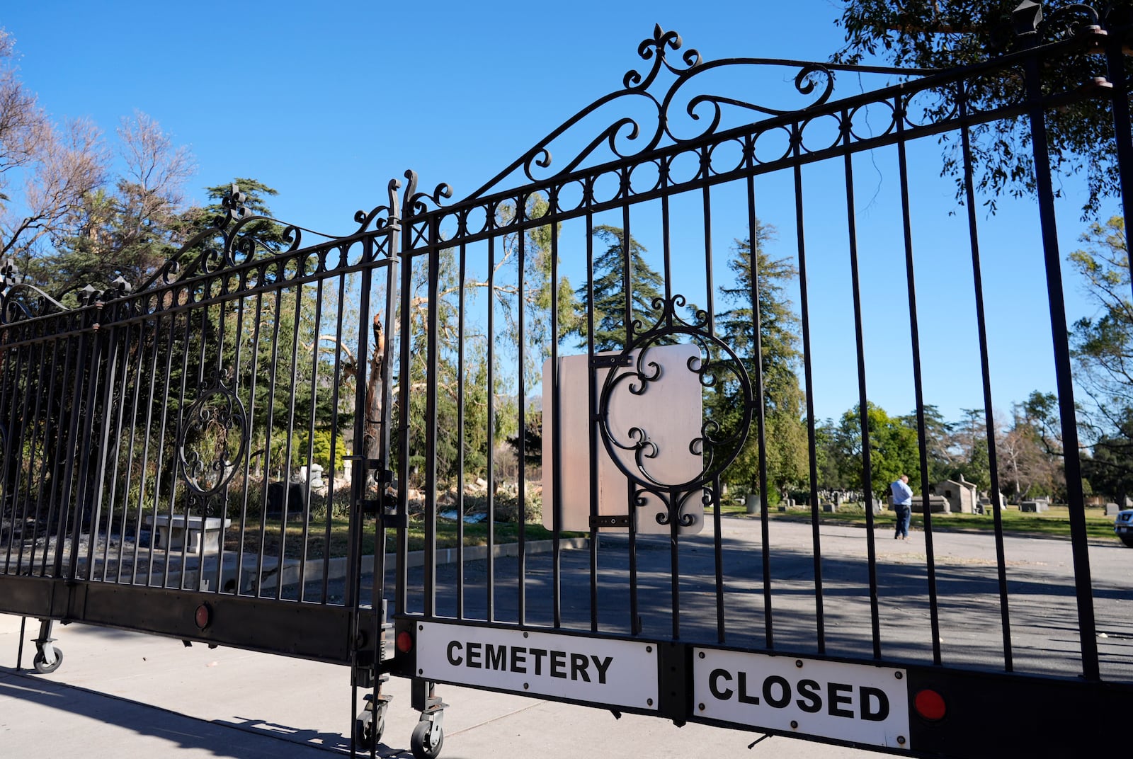 The entrance gate to the closed Mountain View Cemetery is pictured, Tuesday, Jan. 14, 2025, in Altadena, Calif. (AP Photo/Chris Pizzello)