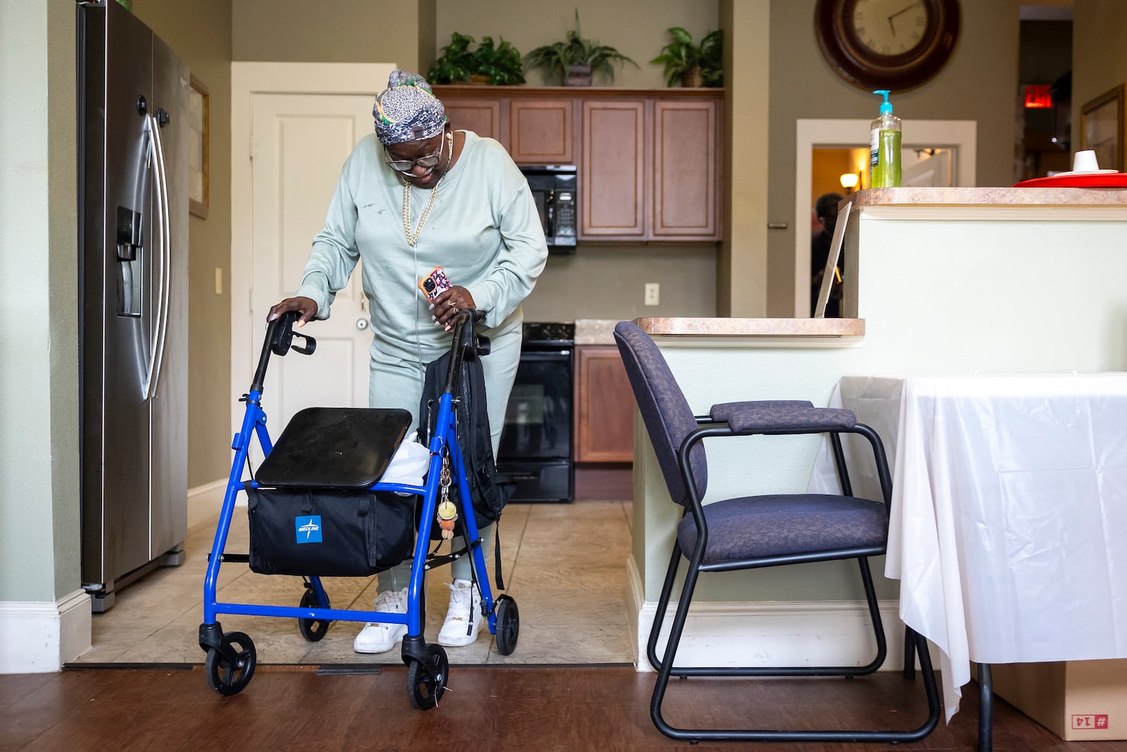 Patricia Johnican passes through a common kitchen area after Wednesday bingo at Commons of Grace Senior on Wednesday, Sept. 25, 2024, in Houston. (AP Photo / Annie Mulligan)