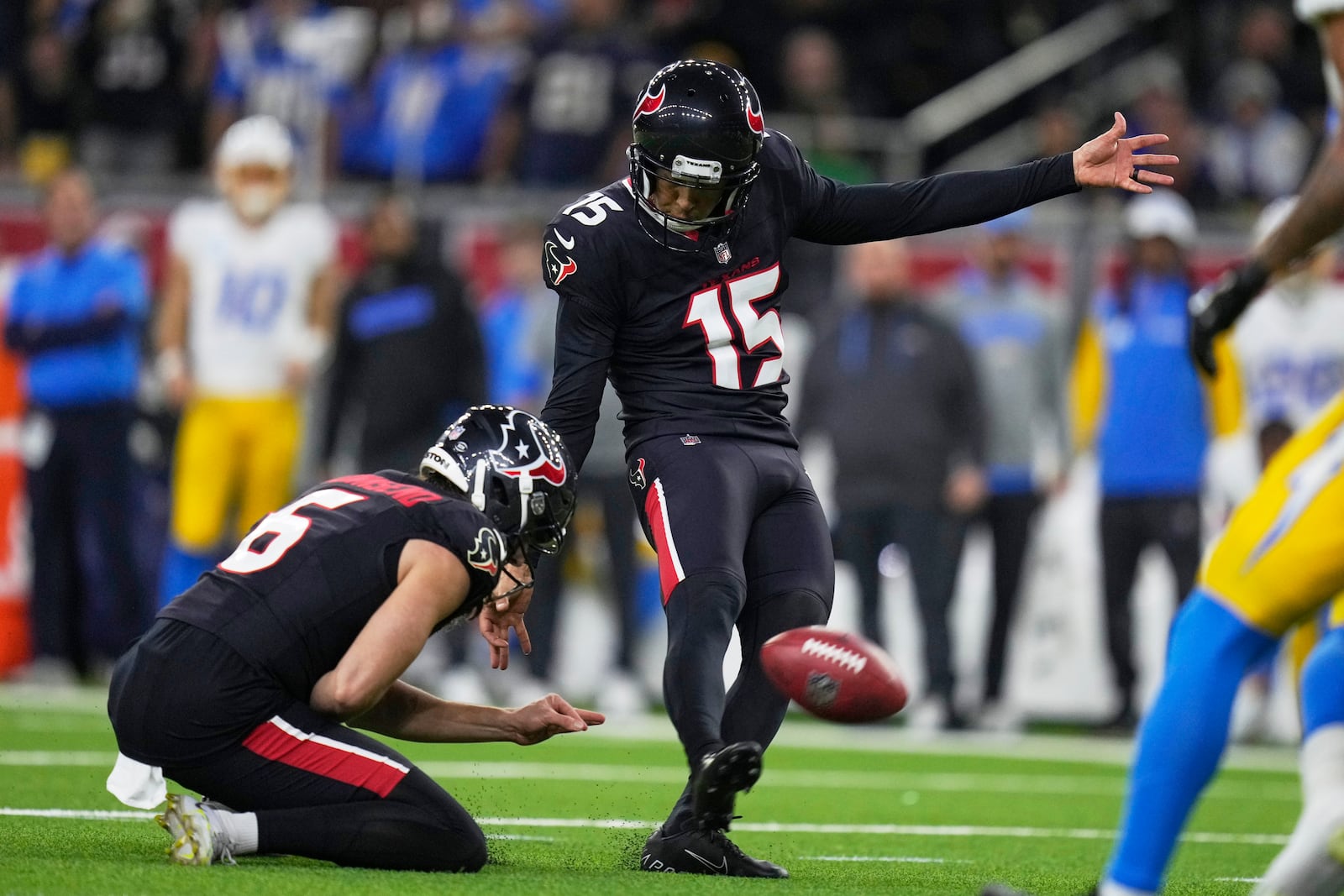 Houston Texans place kicker Ka'imi Fairbairn (15) kicks a field goal against the Los Angeles Chargers during the second half of an NFL wild-card playoff football game Saturday, Jan. 11, 2025, in Houston. (AP Photo/Eric Christian Smith)