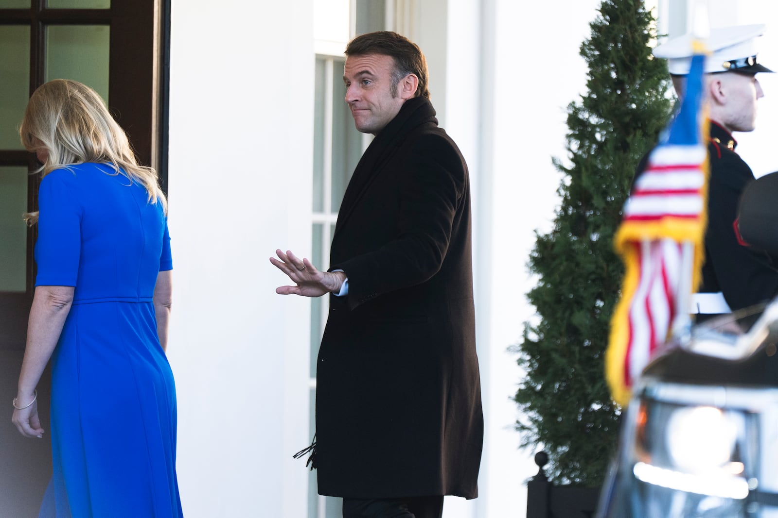 French President Emmanuel Macron is escorted by Chief of Protocol Monica Crowley as he arrives at the White House, Monday, Feb. 24, 2025, in Washington. (AP Photo/Manuel Balce Ceneta)