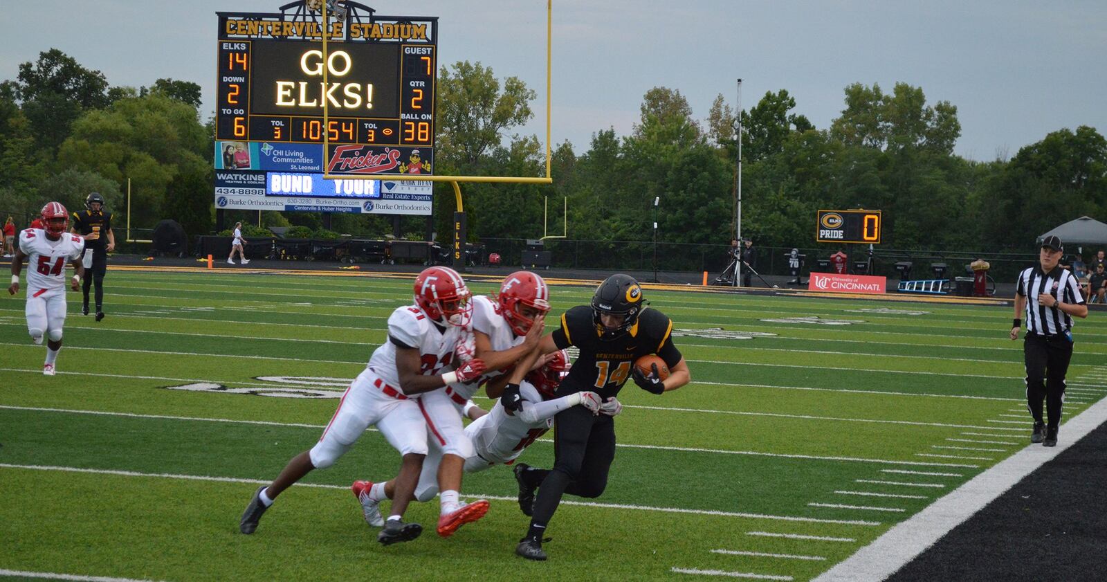 Centerville’s J.R. Melzer (14) is brought down by a trio of Fairfield defenders, including Nykel Bell (31), during Friday night’s game at Centerville Stadium. CONTRIBUTED PHOTO BY ERIC FRANTZ