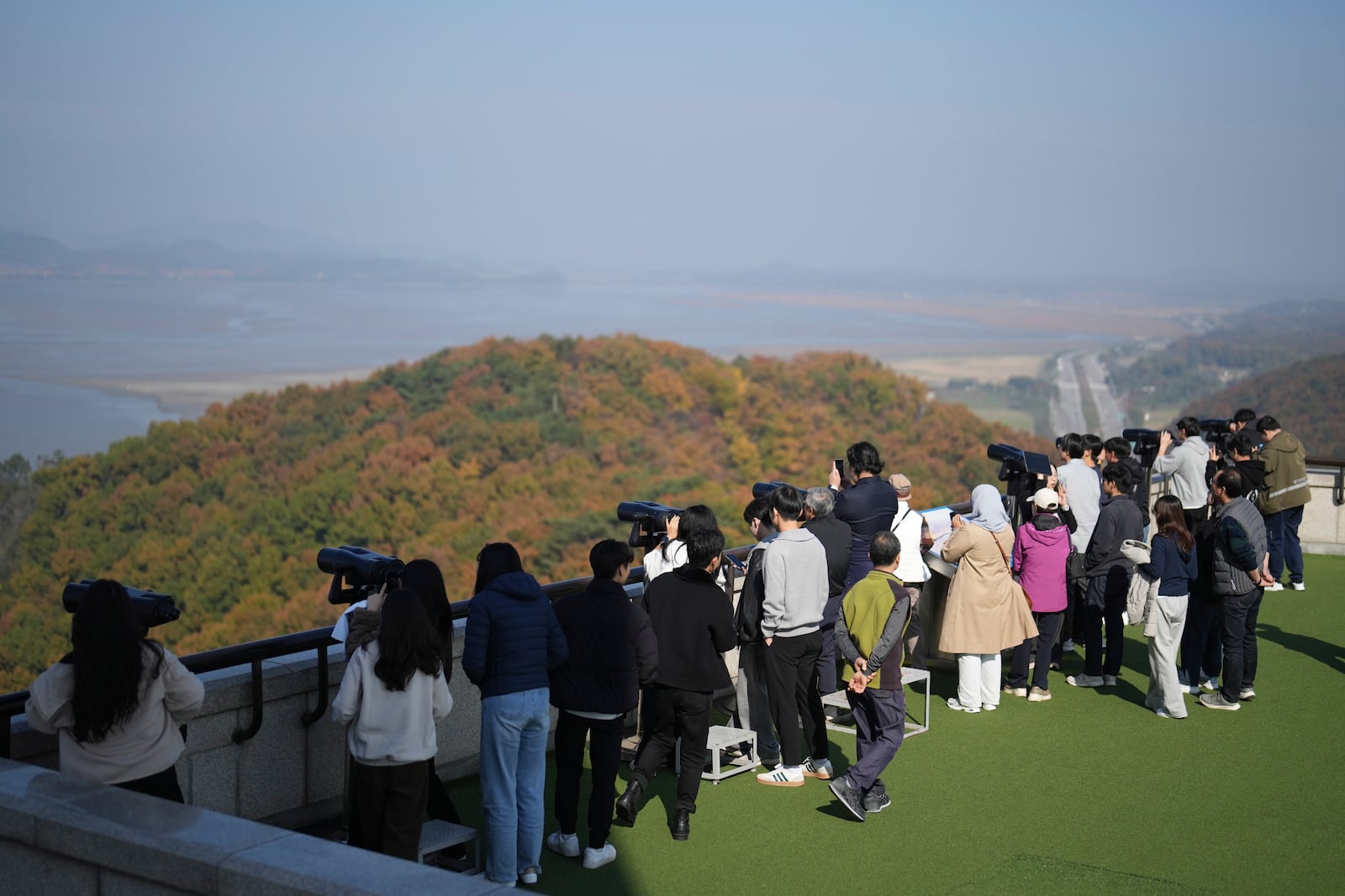 Visitors look at the North Korean side from the unification observatory in Paju, South Korea, Thursday, Oct. 31, 2024. (AP Photo/Lee Jin-man)