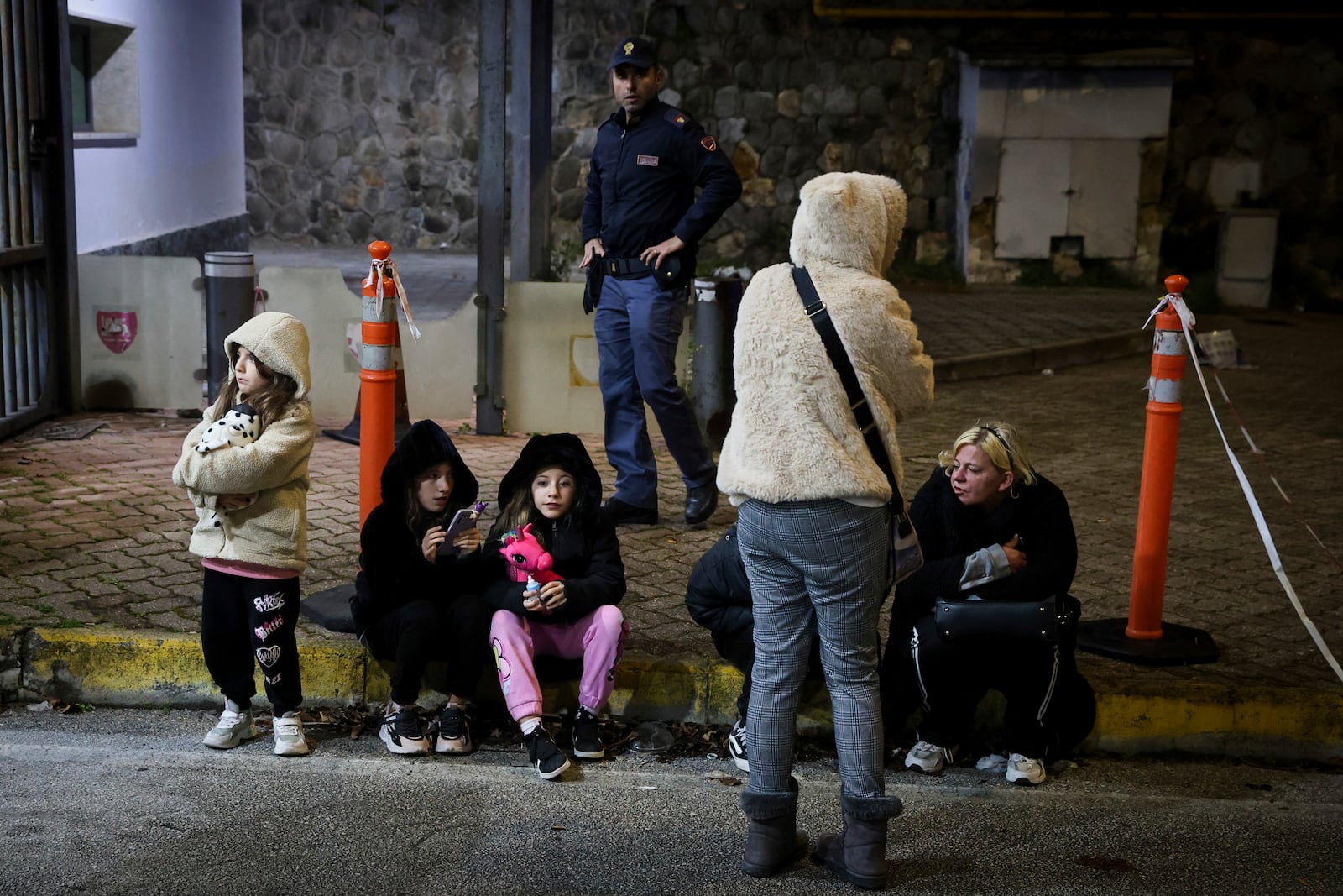 People seek safety in the streets following an earthquake north of Naples, Italy, Thursday, March 13, 2025. (Alessandro Garofalo/LaPresse via AP)