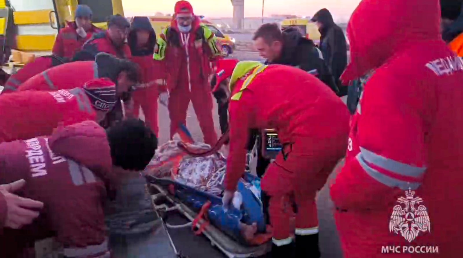 In this image released by the Russian Emergency Ministry Press Service, rescuers prepare to carry a wounded passenger near the Kazakhstani city of Aktau, Thursday, Dec. 26 , 2024, after a plane of Azerbaijani Airline crashed. (Russian Emergency Ministry Press Service via AP)