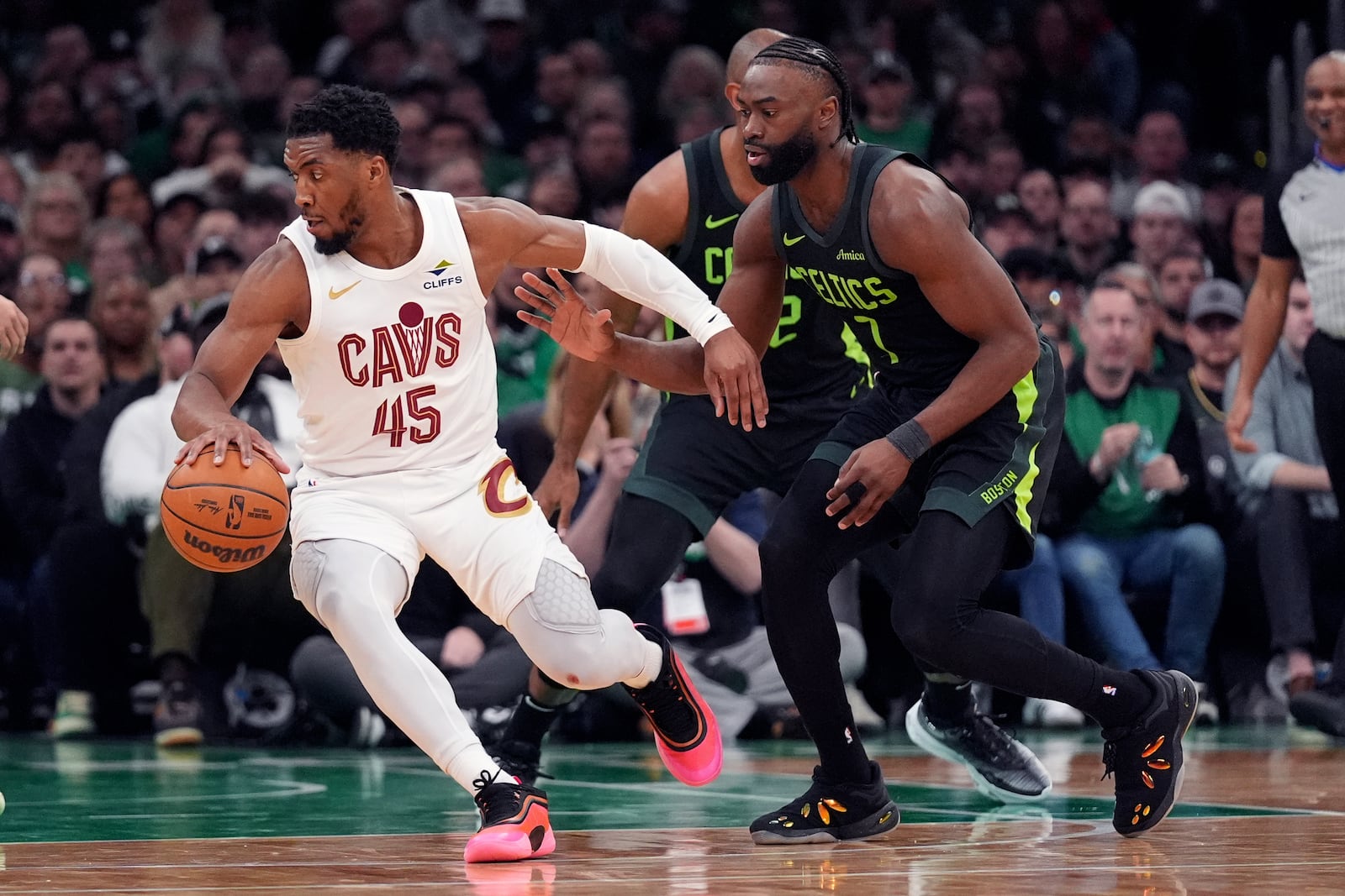 Cleveland Cavaliers guard Donovan Mitchell (45) drives to the basket against Boston Celtics guard Jaylen Brown (7) during the second half of an NBA basketball game, Friday, Feb. 28, 2025, in Boston. (AP Photo/Charles Krupa)