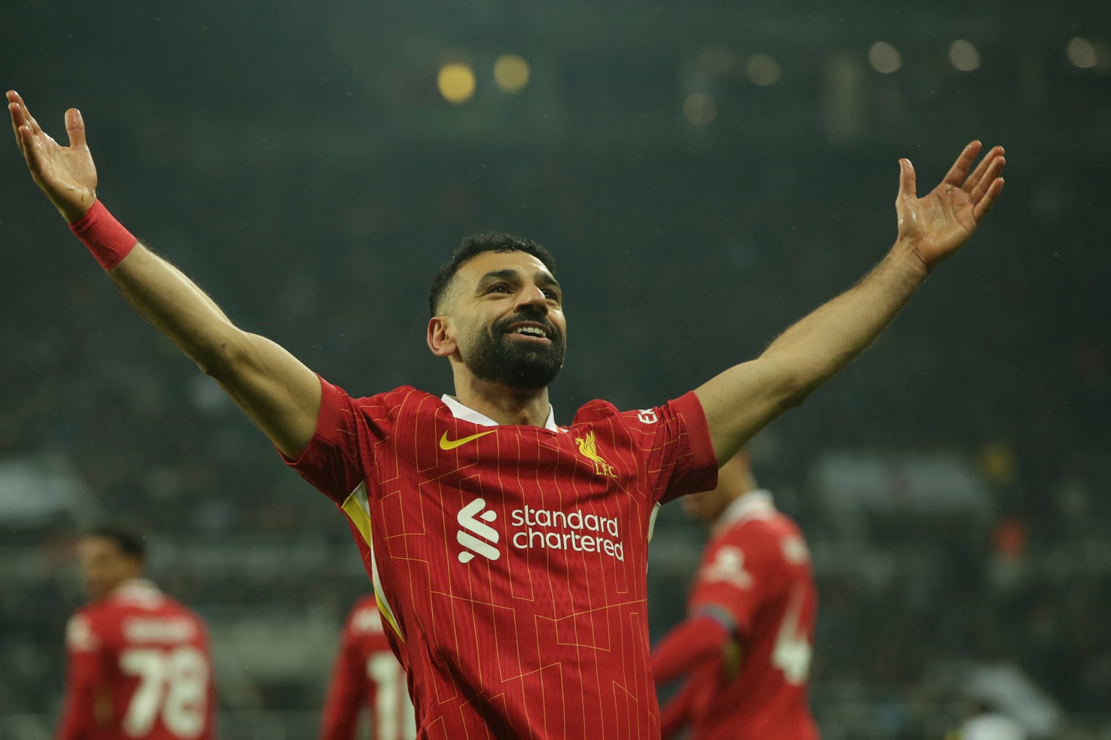 Liverpool's Mohamed Salah celebrates after scoring his side's third goal during the English Premier League soccer match between Newcastle and Liverpool, at St. James Park in Newcastle, England, Wednesday, Dec 4, 2024. (AP Photo/Ian Hodgson)