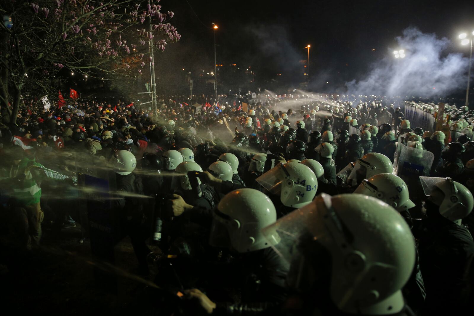 Riot police officers clash with protesters during a protest after Istanbul's Mayor Ekrem Imamoglu was arrested and sent to prison, in Istanbul, Turkey, Sunday, March 23, 2025. (AP Photo/Huseyin Aldemir)