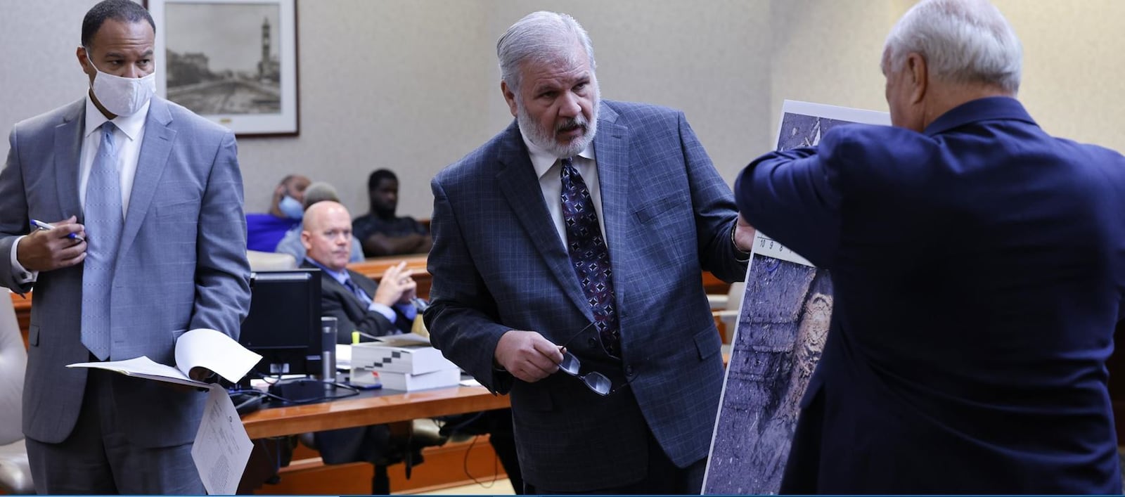 Retired Hamilton Detective Jim Smith testified Tuesday in the murder trial of Mychel King in Butler County Common Pleas Court. King's is accused of killing Jaylon Knight in 2016. Knight's defense attorney, Lawrence Hawkins III is at left and Butler County Prosecutor Michael Gmoser holds a map of Hamilton NICK GRAHAM/STAFF