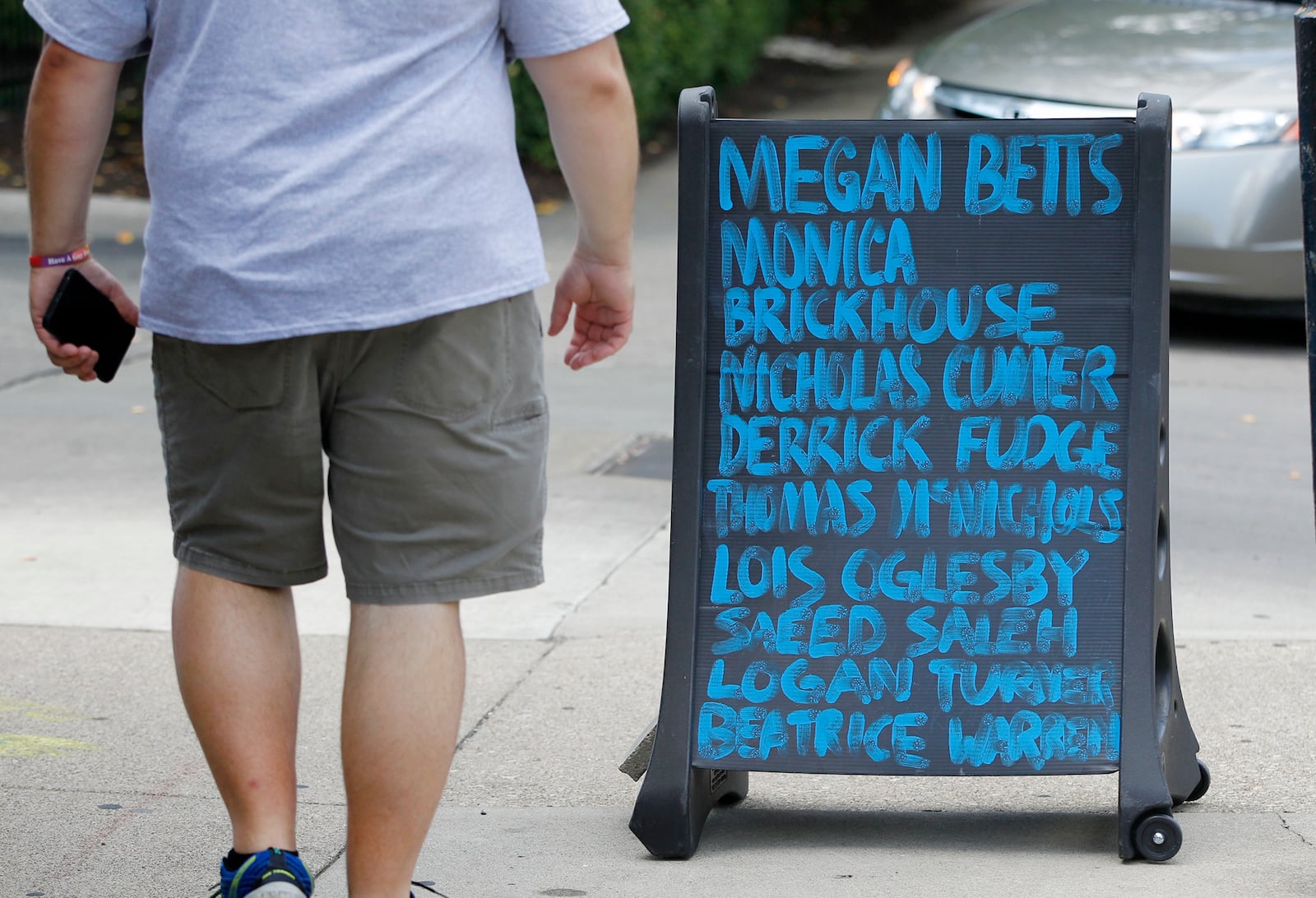 A sign in the Oregon District recognizing the nine victims of the mass shooting on Aug. 4, 2019.  LISA POWELL / STAFF