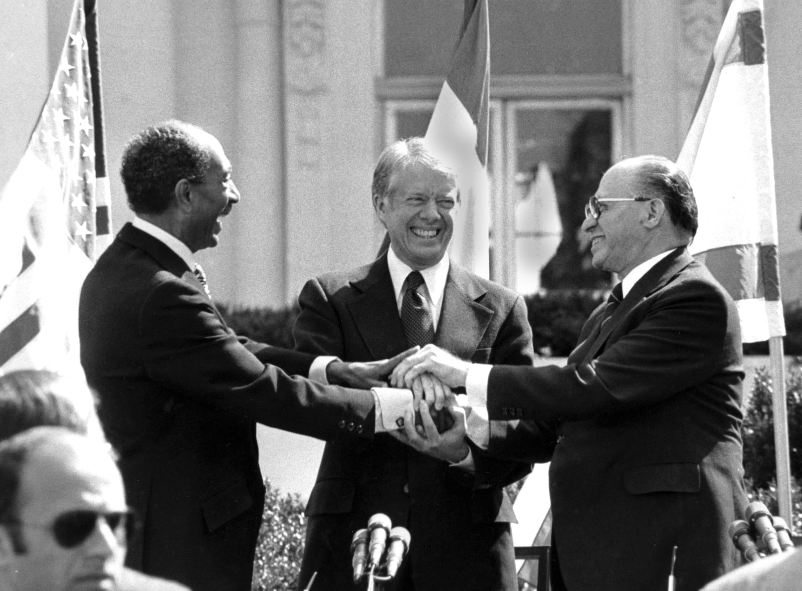 FILE - Egyptian President Anwar Sadat, left, U.S. President Jimmy Carter, center, and Israeli Prime Minister Menachem Begin clasp hands on the north lawn of the White House after signing the peace treaty between Egypt and Israel, March 26, 1979, in Washington. (AP Photo/ Bob Daugherty, File)