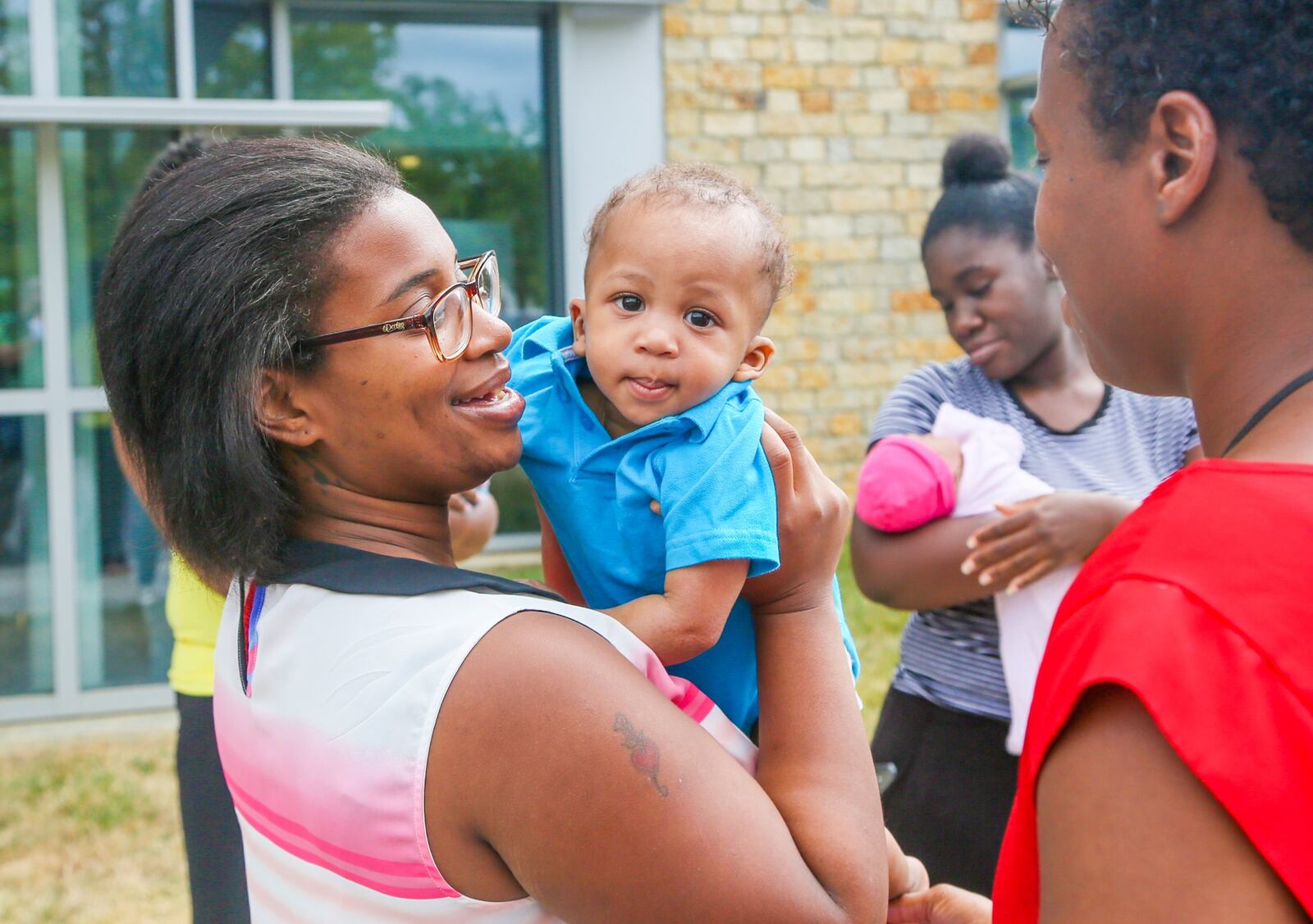 Mary Lockhart and her son, Jeremiah Hodges, participate in a PRIM Community Action Team event outside Primary Health Solutions Health Center in Middletown, Tuesday, Aug. 29. GREG LYNCH / STAFF