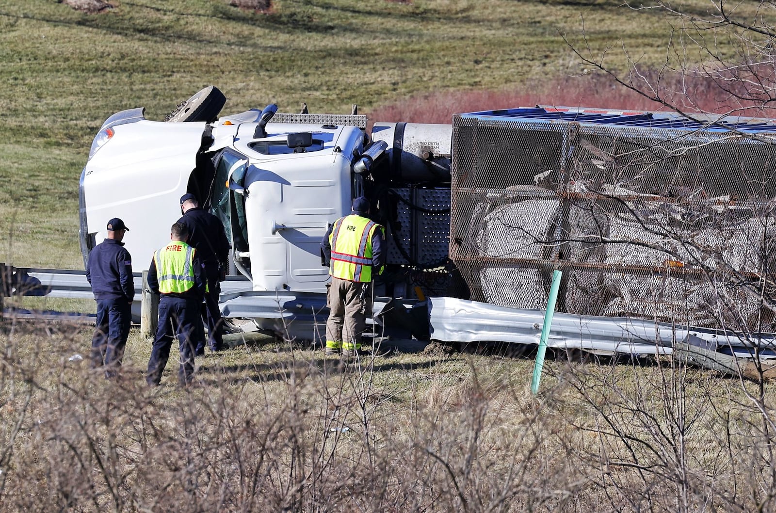 A semi hauling crushed cars rolled over on its side on the ramp from eastbound Ohio 122 to I-75 northbound in Middletown. NICK GRAHAM / STAFF