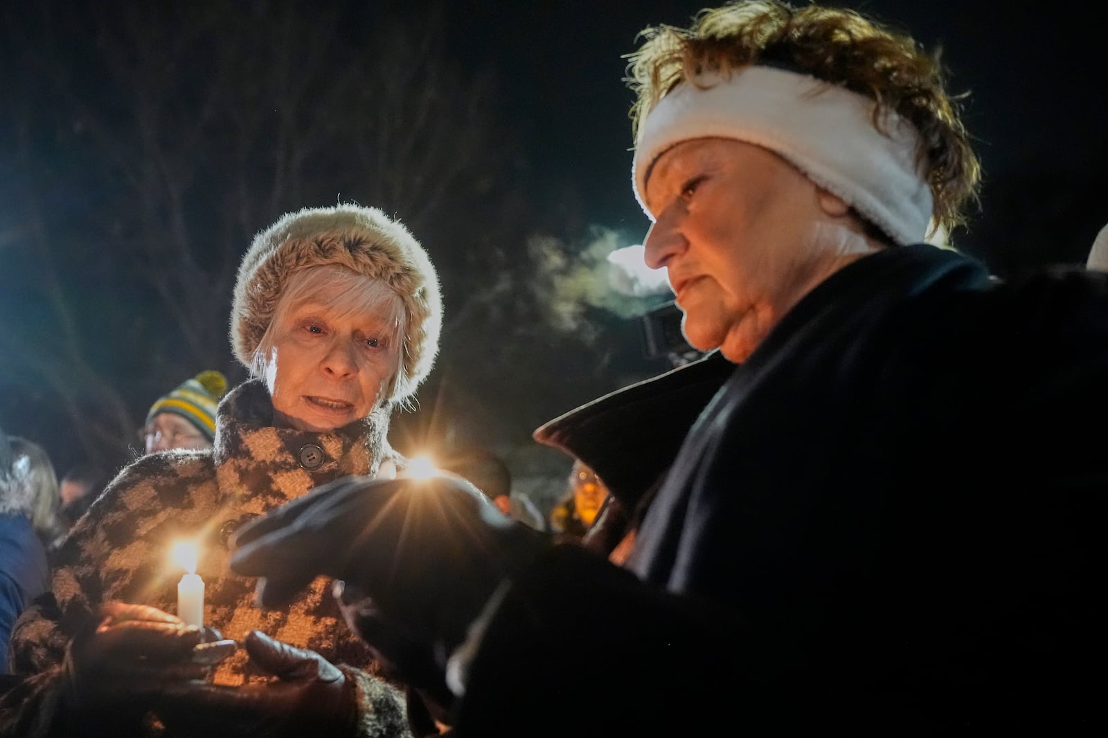 Supporters hold candles during a candlelight vigil Tuesday, Dec. 17, 2024, outside the Wisconsin Capitol in Madison, Wis., following a shooting at the Abundant Life Christian School on Monday, Dec. 16. (AP Photo/Morry Gash)