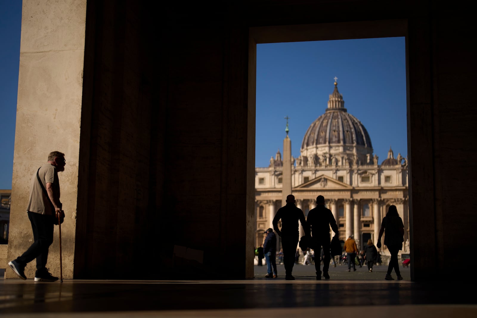 People walk next to St. Peter's Square at the Vatican, Thursday, March 6, 2025. (AP Photo/Francisco Seco)