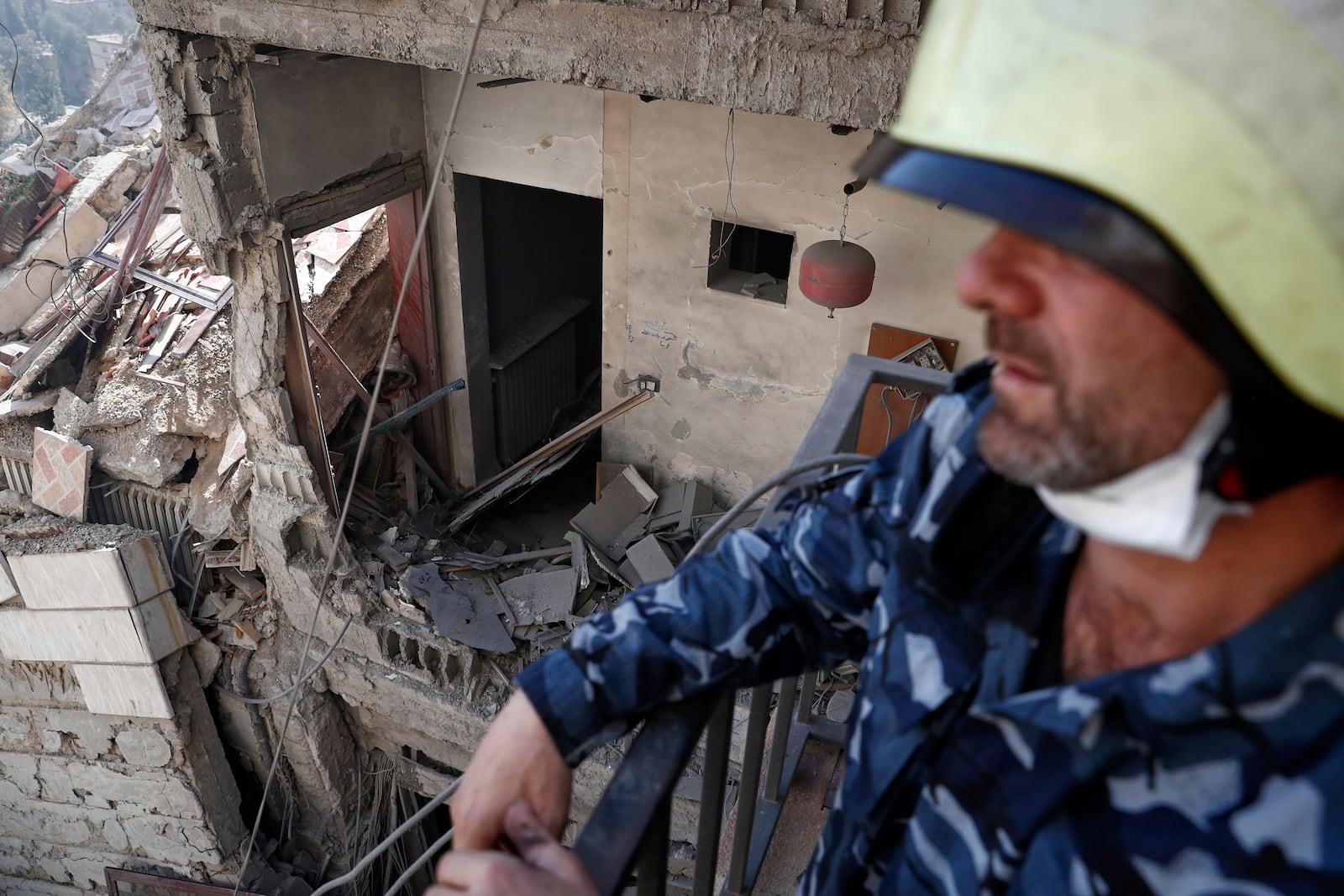 Firemen work at the site of an Israeli missile strike in Damascus, Syria, Thursday March 13, 2025.(AP Photo/Omar Sanadiki)