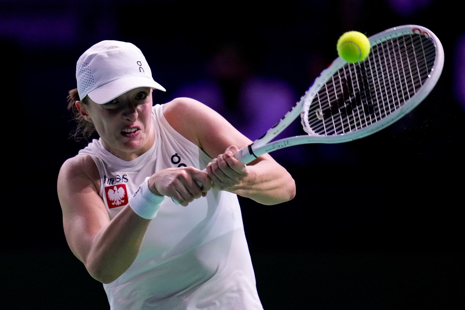 Poland's Iga Swiatek returns the ball to Spain's Paula Badosa during the Billie Jean King Cup Finals, at the Martin Carpena Sports Hall, in Malaga, southern Spain, on Friday, Nov. 15, 2024. (AP Photo/Manu Fernandez)