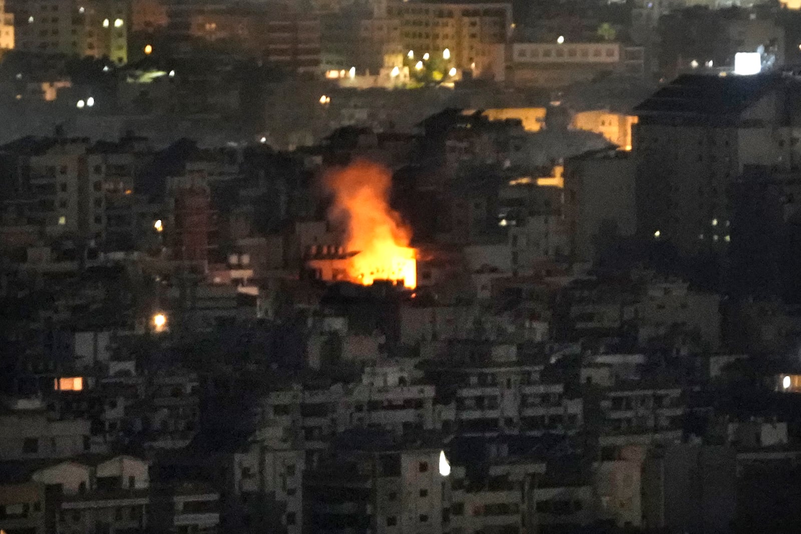 Flame rise from a building that was hit by an Israeli airstrike on Dahiyeh, in the southern suburb of Beirut, Lebanon, Sunday, Oct. 20, 2024. (AP Photo/Hussein Malla)