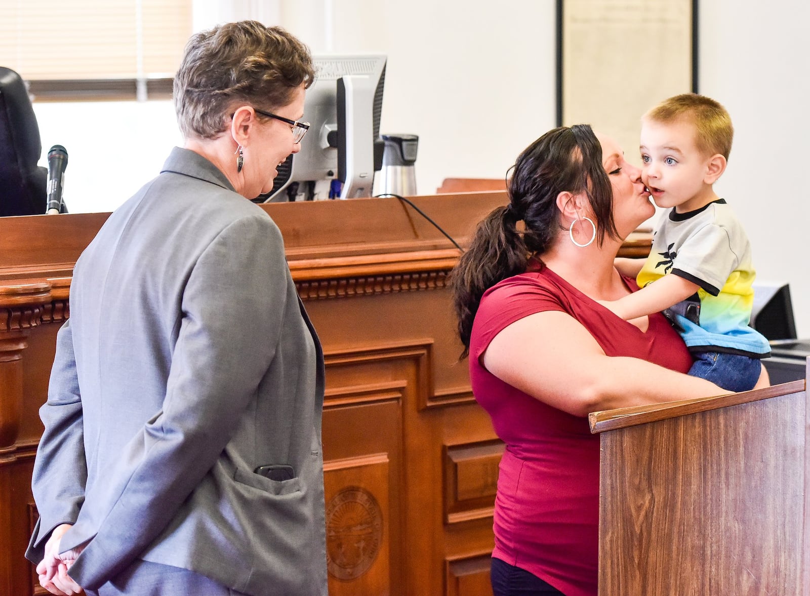 Magistrate Patricia Wilkerson (left) stands with Megan Franken and her son Braxton during Franken’s transition ceremony from the Butler County Juvenile Court Family Treatment Drug Court Program. 