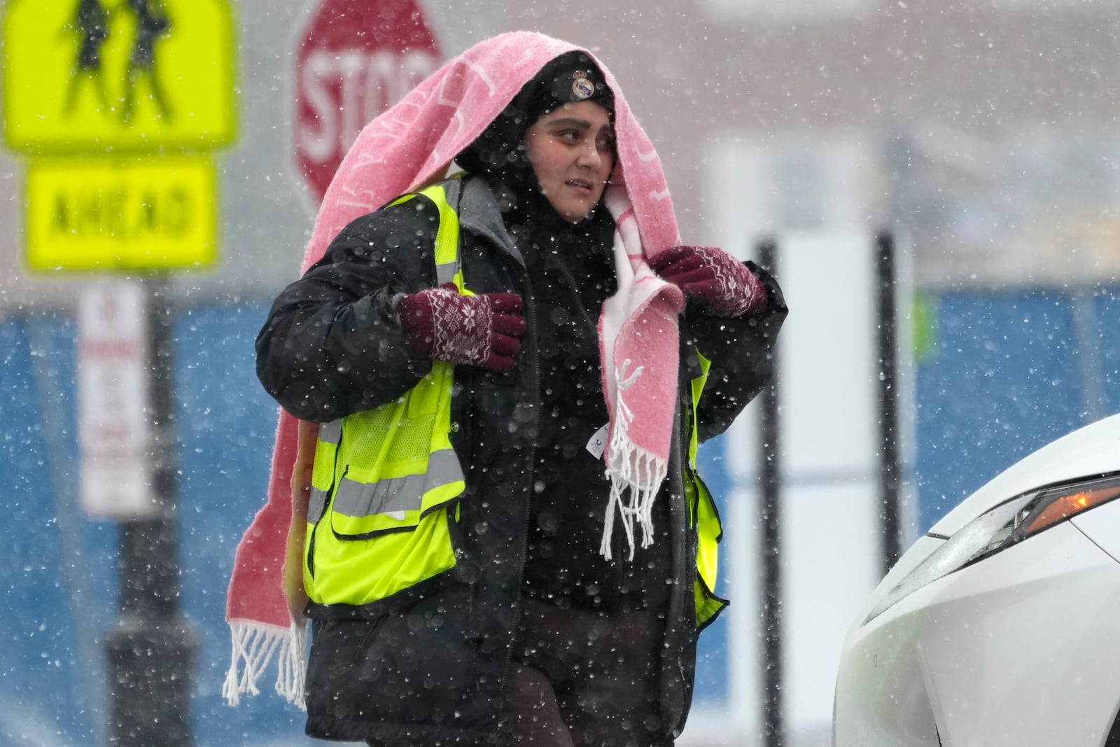 A parking attendant waits to help drivers at a Northwestern University parking lot during a snow day in Evanston, Ill., Sunday, Jan. 12, 2025. (AP Photo/Nam Y. Huh)