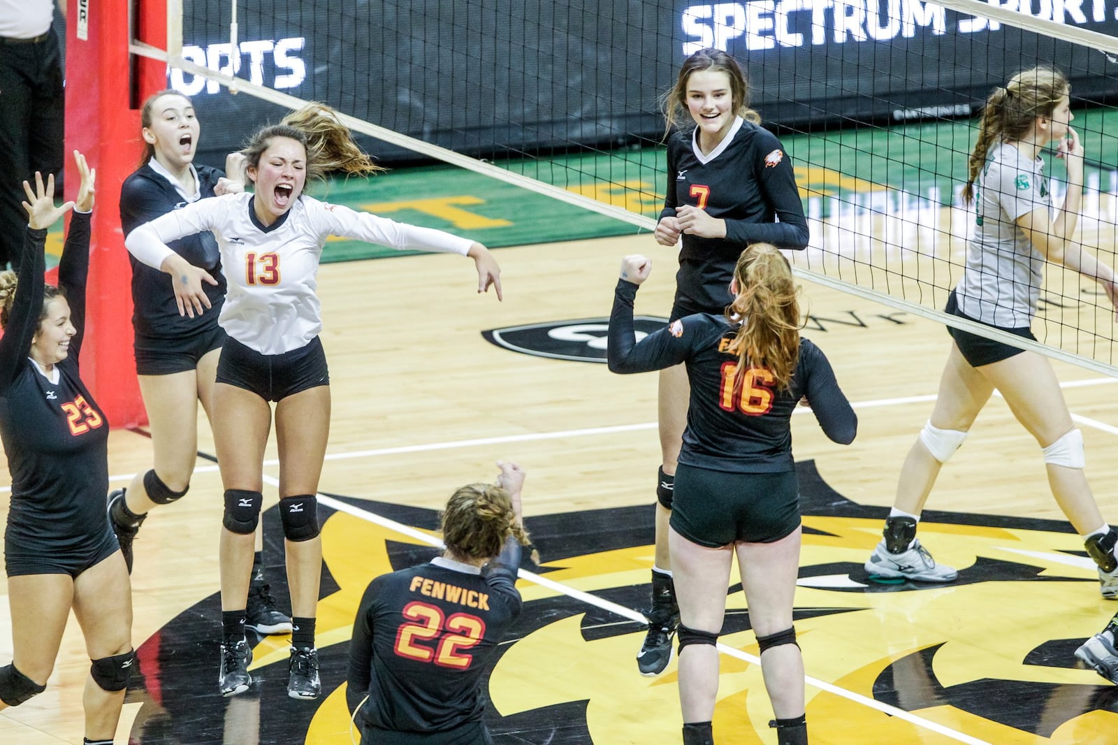 Fenwick’s Bella DeSalvo (13), Brooklyn Brunner (23), Emma Schaefer (22), Grace Maziar (16), Elizabeth Hoerlein (7) and Julia Gardon celebrate a point during Friday’s Division II state volleyball semifinal against Parma Heights Holy Name at Wright State University’s Nutter Center. NICK GRAHAM/STAFF