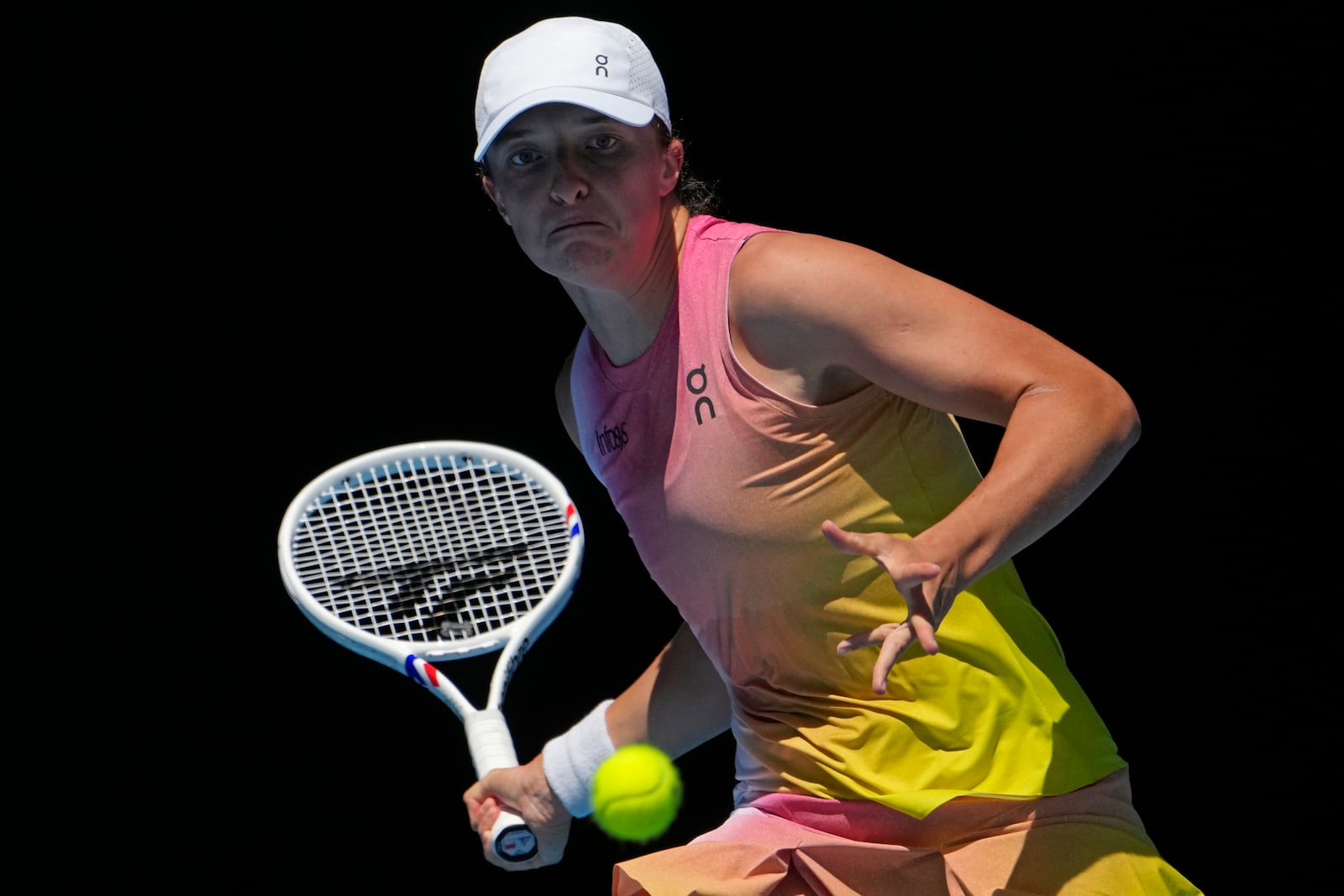 Iga Swiatek of Poland plays a forehand return to Rebecca Sramkova of Slovakia during their second round match at the Australian Open tennis championship in Melbourne, Australia, Thursday, Jan. 16, 2025. (AP Photo/Asanka Brendon Ratnayake)