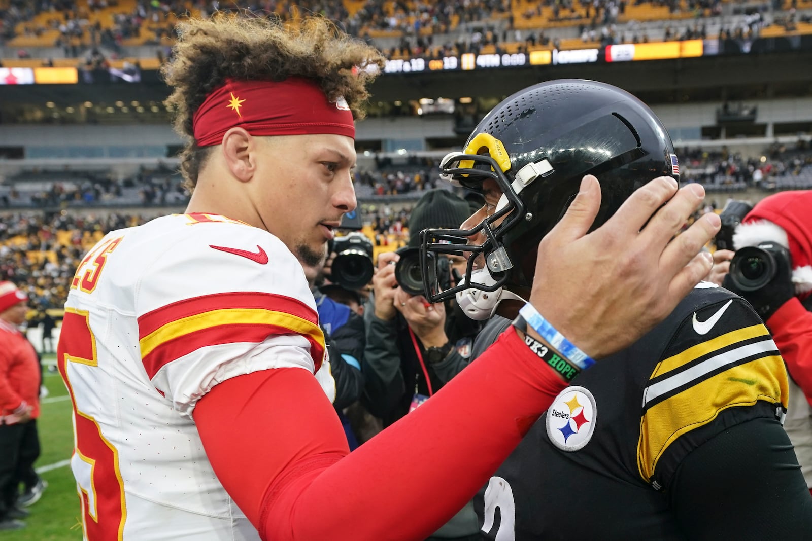 Kansas City Chiefs quarterback Patrick Mahomes (15) speaks with Pittsburgh Steelers quarterback Russell Wilson (3) after an NFL football game, Wednesday, Dec. 25, 2024, in Pittsburgh. (AP Photo/Matt Freed)