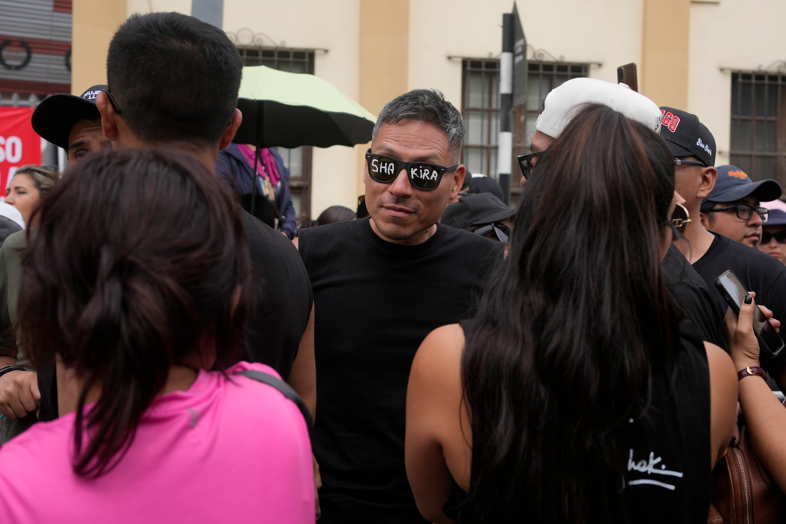 Fans of Colombian pop star Shakira react outside of the National Stadium upon learning she canceled her concert after being hospitalized, in Lima, Peru, Sunday, Feb. 16, 2025. (AP Photo/Martin Mejia)