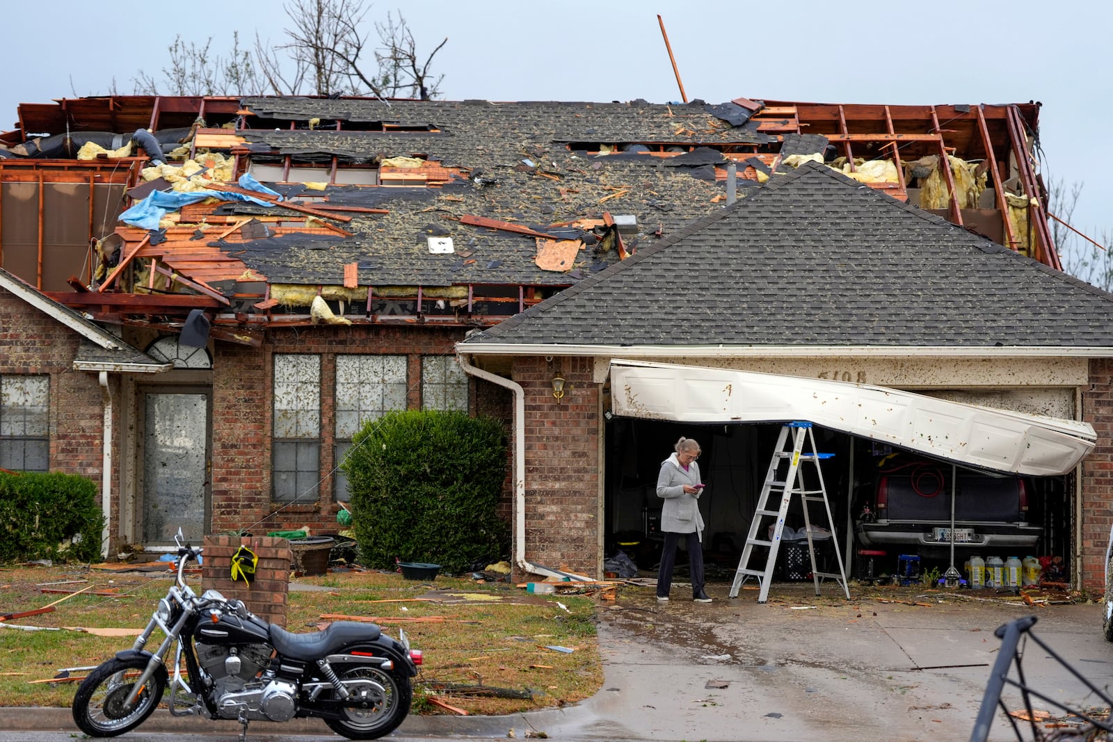 A women stands near a damaged home along SE 84 after a tornado hit the area in Oklahoma City, Sunday, Nov. 3, 2024. (Bryan Terry/The Oklahoman via AP)