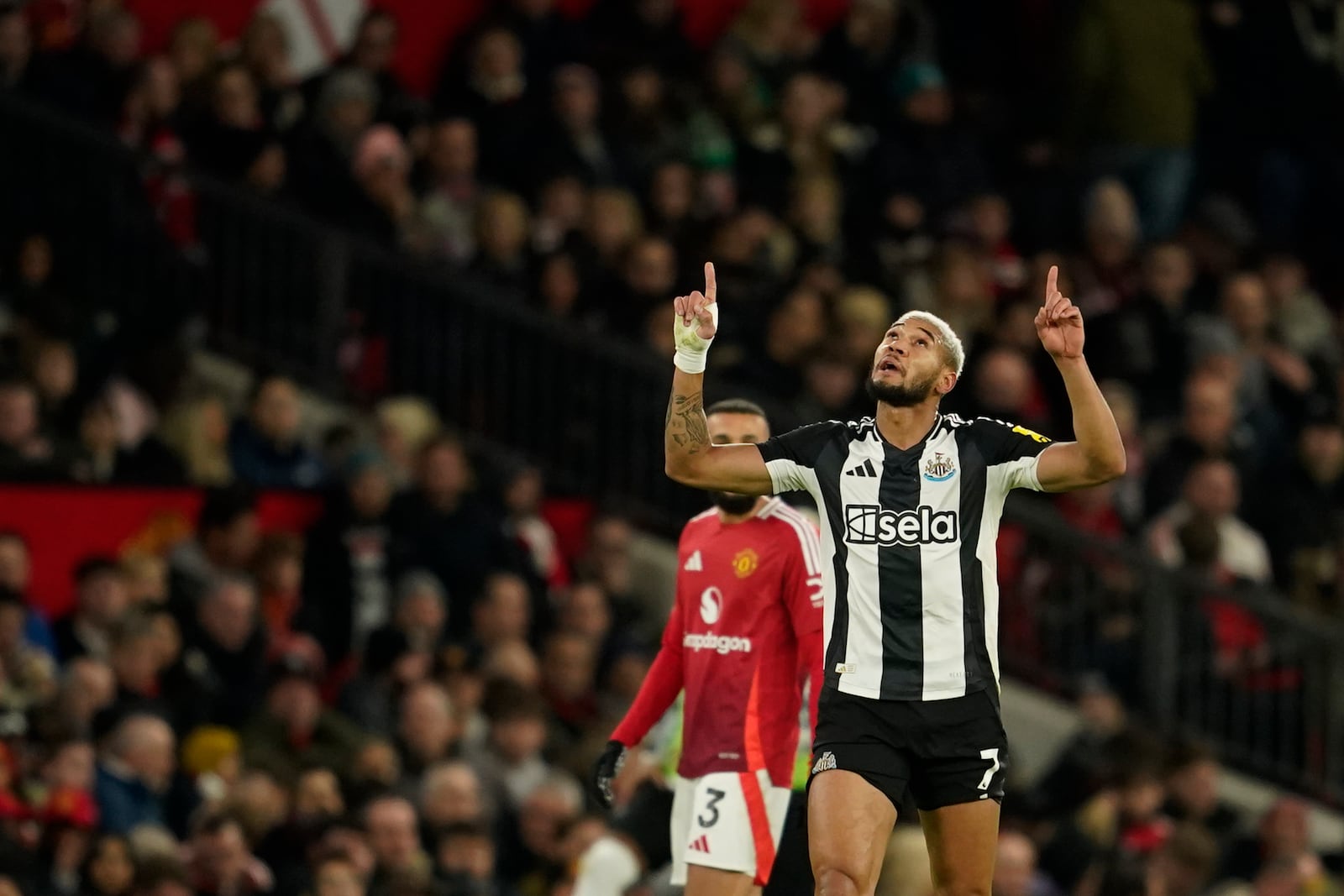 Newcastle's Joelinton celebrates after scoring his side's second goal during the English Premier League soccer match between Manchester United and Newcastle at the Old Trafford stadium in Manchester, England, Monday, Dec. 30, 2024. (AP Photo/Dave Thompson)