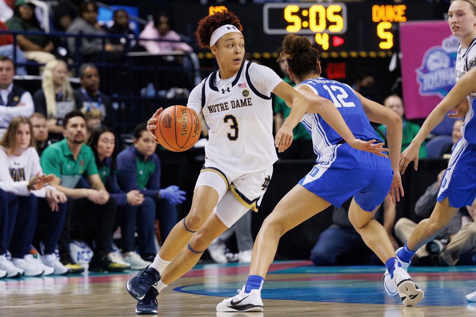 FILE - Notre Dame's Hannah Hidalgo (3) handles the ball as Duke's Delaney Thomas (12) defends during the second half of an NCAA college basketball game in the semifinals of the Atlantic Coast Conference tournament in Greensboro, N.C., Saturday, March 8, 2025. (AP Photo/Ben McKeown)