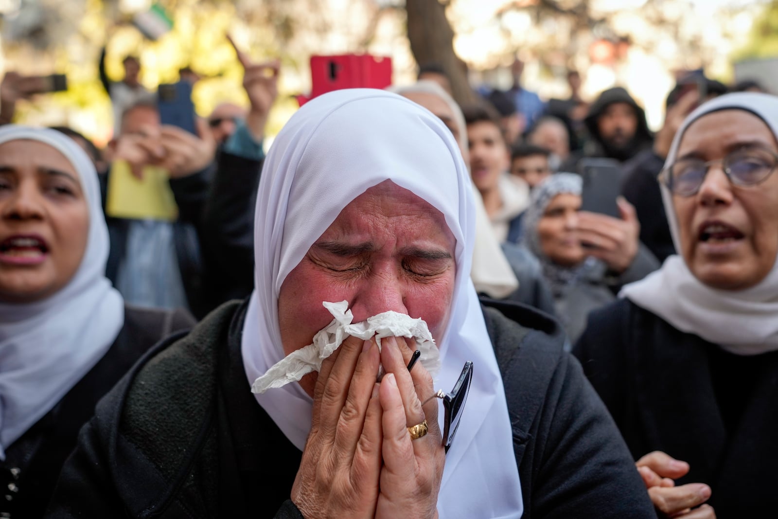 A woman weeps during the funeral of Syrian activist Mazen al-Hamada in Damascus Thursday Dec. 12, 2024. Al-Hamad's mangled corpse was found wrapped in a bloody sheet in Saydnaya prison. He had fled to Europe but returned to Syria in 2020 and was imprisoned upon arrival. (AP Photo/Hussein Malla)