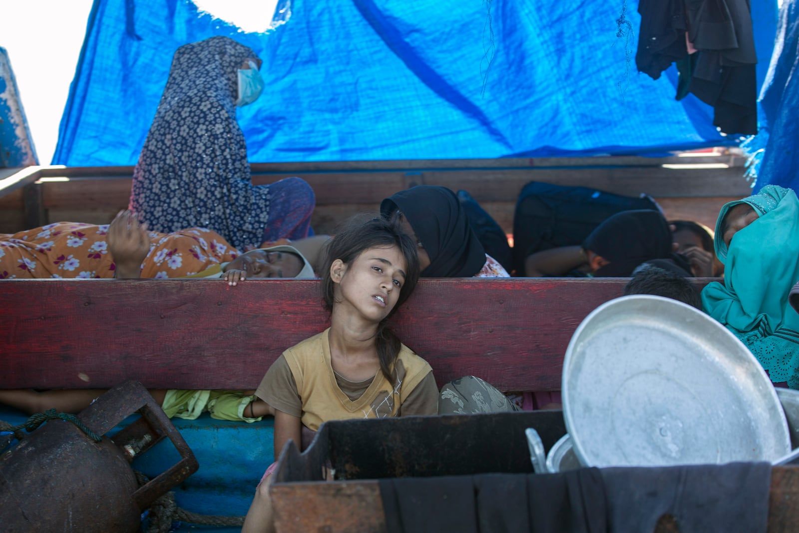 A young Rohingya girl sits on the deck of a refugee boat anchored in the waters near the coast of Labuhan Haji, Aceh province, Indonesia, Tuesday, Oct. 22, 2024. (AP Photo/Binsar Bakkara)