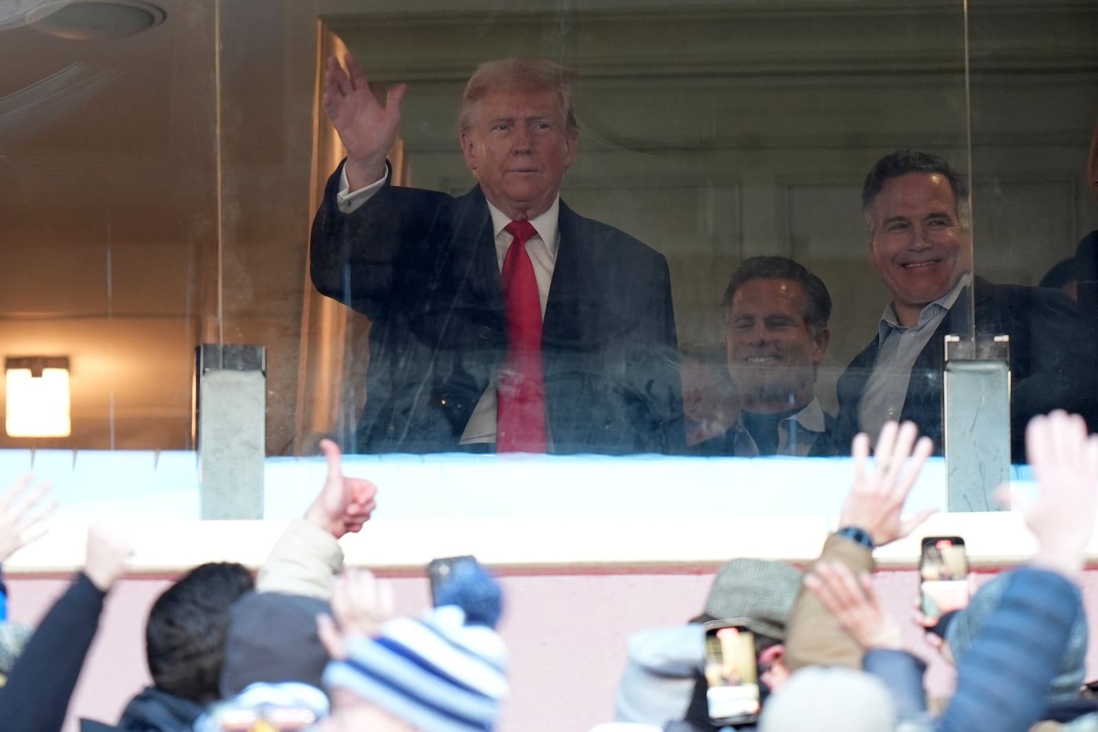 President-elect Donald Trump, left, joined by Senator-elect Dave McCormick, R-Pa., right, gestures to the crowd as he attends the NCAA college football game between Army and Navy at Northwest Stadium in Landover, Md., Saturday, Dec. 14, 2024. (AP Photo/Stephanie Scarbrough)