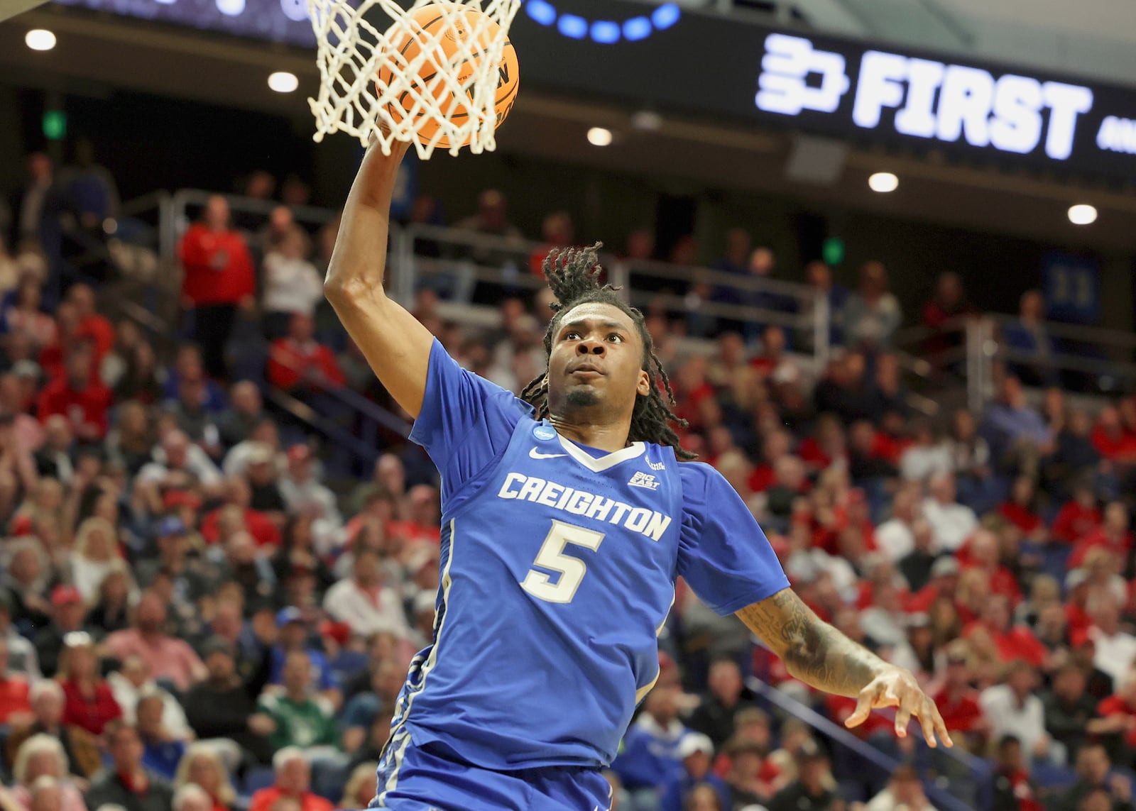 Creighton's Jamiya Neal (5) dunks during the first half against Louisville in the first round of the NCAA college basketball tournament in Lexington, Ky., Thursday, March 20, 2022. (AP Photo/James Crisp)