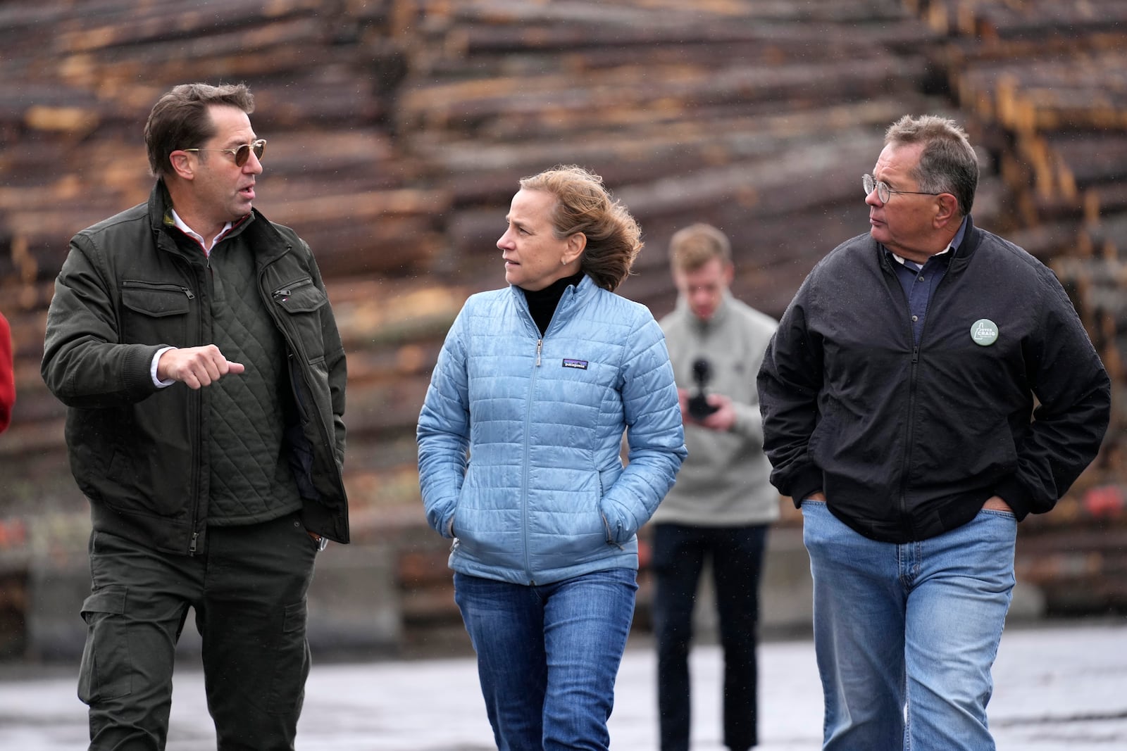 Joyce Craig, Democratic candidate for governor, talks with Mark Brady, administrator of Coos County, left, and Paul Grenier, former mayor of Berlin, N.H., during a visit to the Milan Lumber mill, Wednesday, Oct. 16, 2024, in Milan, N.H. (AP Photo/Robert F. Bukaty)