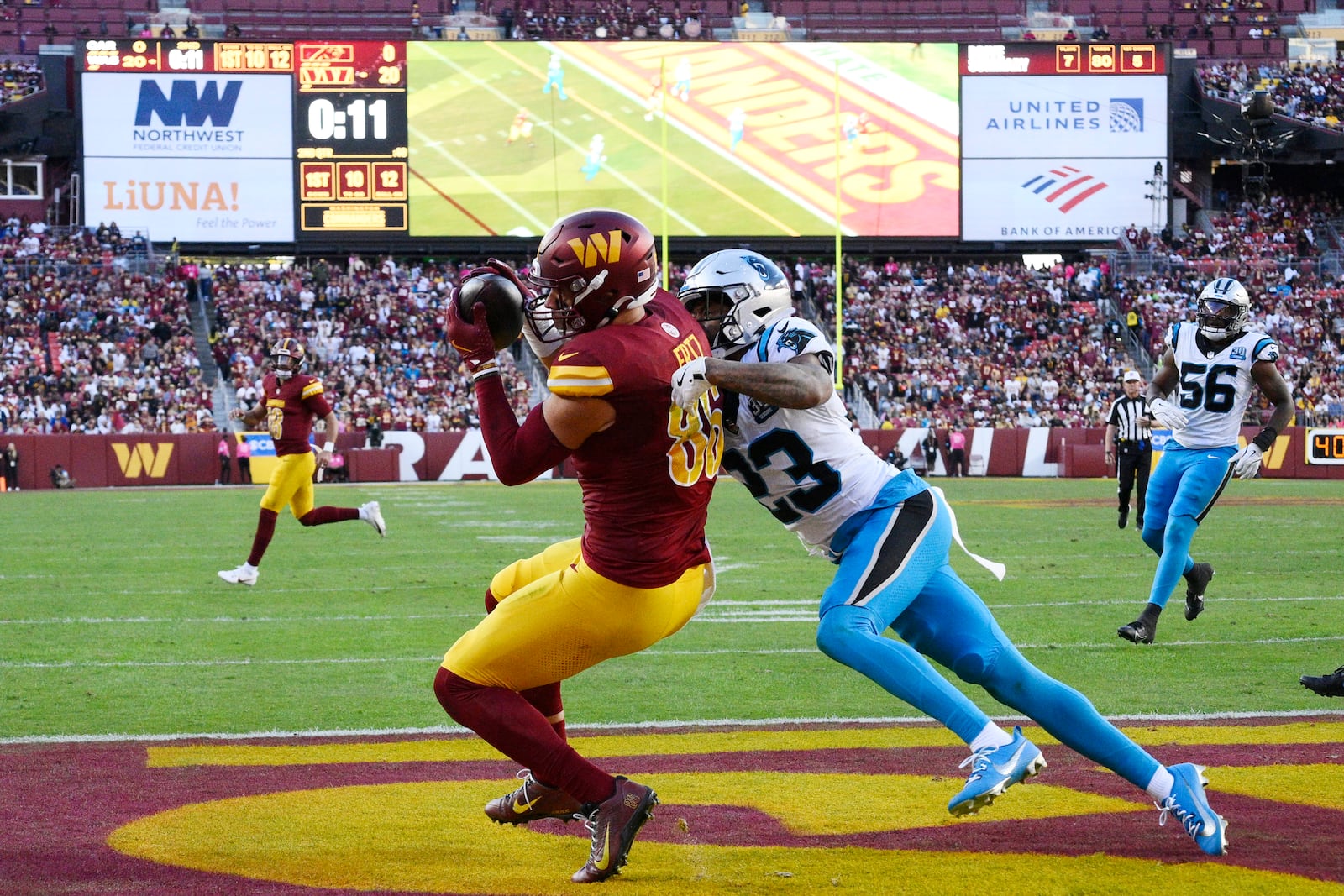 Washington Commanders tight end Zach Ertz (86) catches a 12-yard touchdown pass in front of Carolina Panthers cornerback Dane Jackson (23) during the first half of an NFL football game, Sunday, Oct. 20, 2024, in Landover, Md. (AP Photo/Nick Wass)